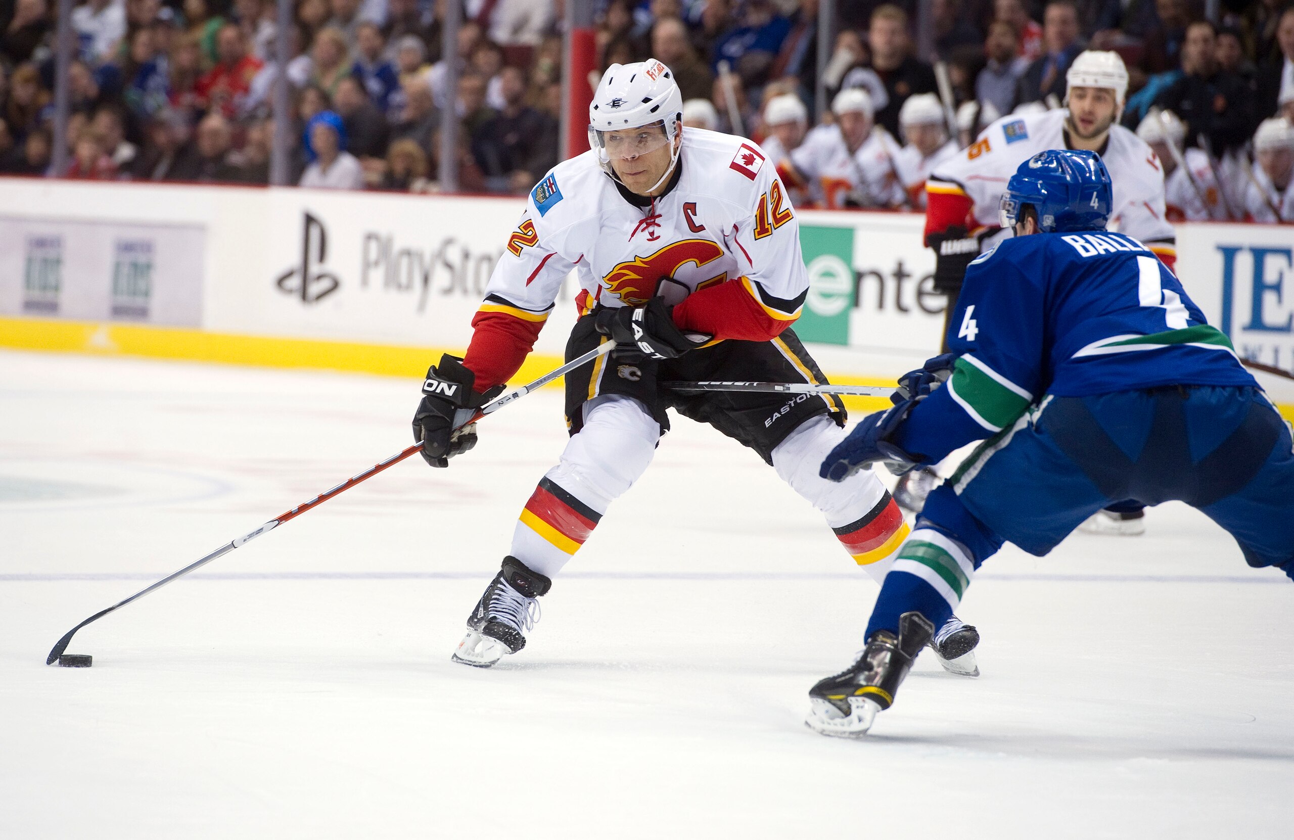 VANCOUVER, CANADA - JANUARY 5: Jarome Iginla #12 of the Calgary Flames tries to get past Keith Ballard #4 of the Vancouver Canucks with a toe drag move during the first period in NHL action on January 05, 2011 at Rogers Arena in Vancouver, BC, Canada.  (P
