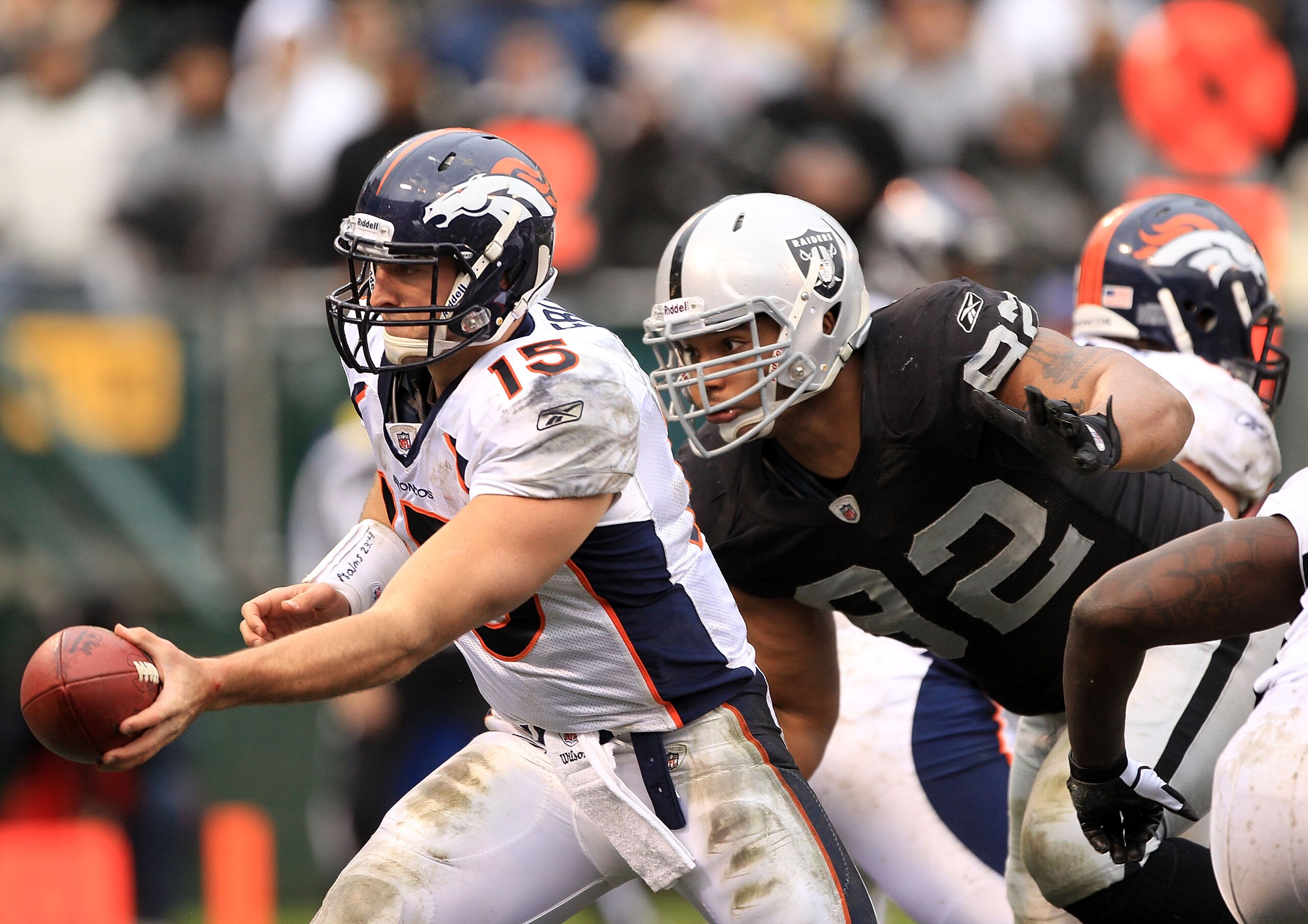 OAKLAND, CA - DECEMBER 19: Tim Tebow #15 of the Denver Broncos hands off the ball before being hit by Richard Seymour #92 of the Oakland Raiders at Oakland-Alameda County Coliseum on December 19, 2010 in Oakland, California. (Photo by Ezra Shaw/Getty Im OAKLAND, CA - DECEMBER 19: Tim Tebow #15 of the Denver Broncos hands off the ball before being hit by Richard Seymour #92 of the Oakland Raiders at Oakland-Alameda County Coliseum on December 19, 2010 in Oakland, California. (Photo by Ezra Shaw/Getty Im