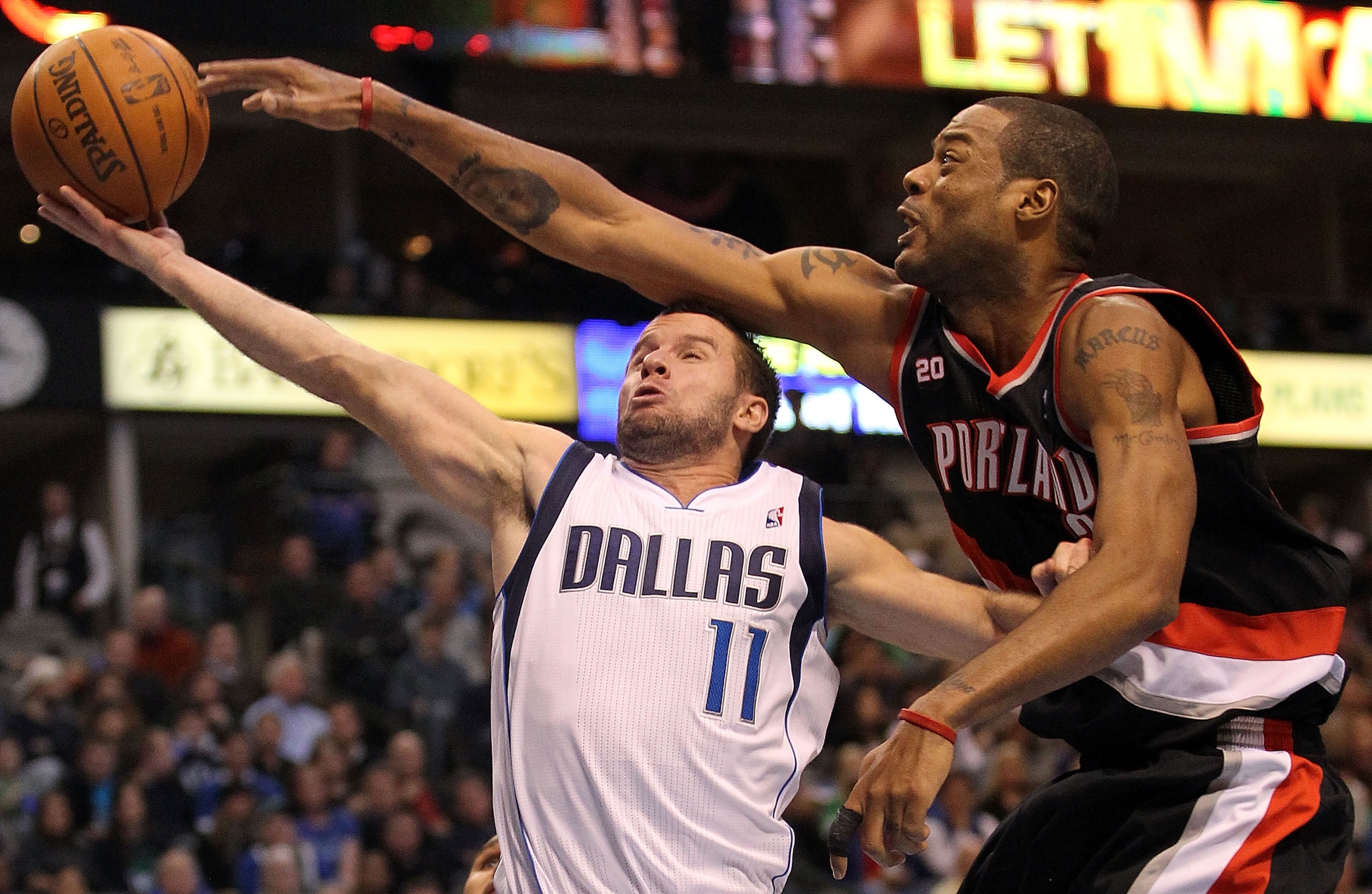 DALLAS, TX - JANUARY 04: Guard Jose Juan Barea #11 of the Dallas Mavericks takes a shot against Marcus Camby #23 of the Portland Trail Blazers at American Airlines Center on January 4, 2011 in Dallas, Texas. NOTE TO USER: User expressly acknowledges and DALLAS, TX - JANUARY 04: Guard Jose Juan Barea #11 of the Dallas Mavericks takes a shot against Marcus Camby #23 of the Portland Trail Blazers at American Airlines Center on January 4, 2011 in Dallas, Texas. NOTE TO USER: User expressly acknowledges and
