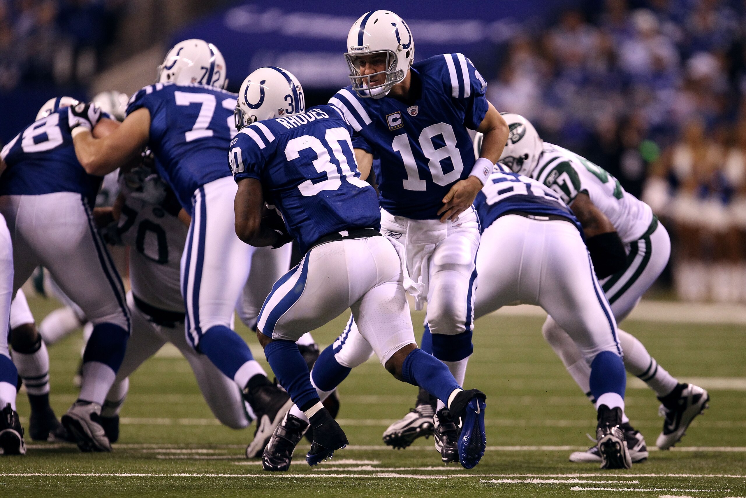 INDIANAPOLIS, IN - JANUARY 08: Peyton Manning #18 of the Indianapolis Colts hands the ball off to Dominci Rhodes #30 against the New York Jets during their 2011 AFC wild card playoff game at Lucas Oil Stadium on January 8, 2011 in Indianapolis, Indiana. INDIANAPOLIS, IN - JANUARY 08: Peyton Manning #18 of the Indianapolis Colts hands the ball off to Dominci Rhodes #30 against the New York Jets during their 2011 AFC wild card playoff game at Lucas Oil Stadium on January 8, 2011 in Indianapolis, Indiana.