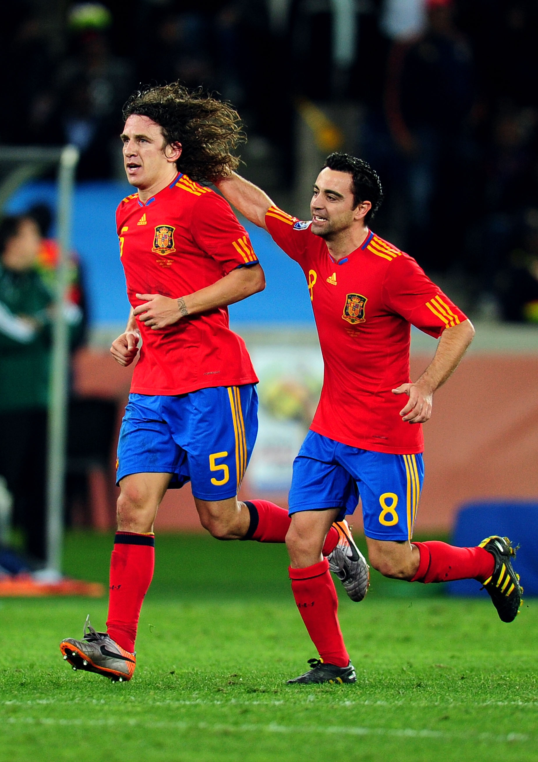 DURBAN, SOUTH AFRICA - JULY 07:  Carles Puyol of Spain celebrates scoring his side's first goal with team mate Xavi Hernandez (R) during the 2010 FIFA World Cup South Africa Semi Final match between Germany and Spain at Durban Stadium on July 7, 2010 in D