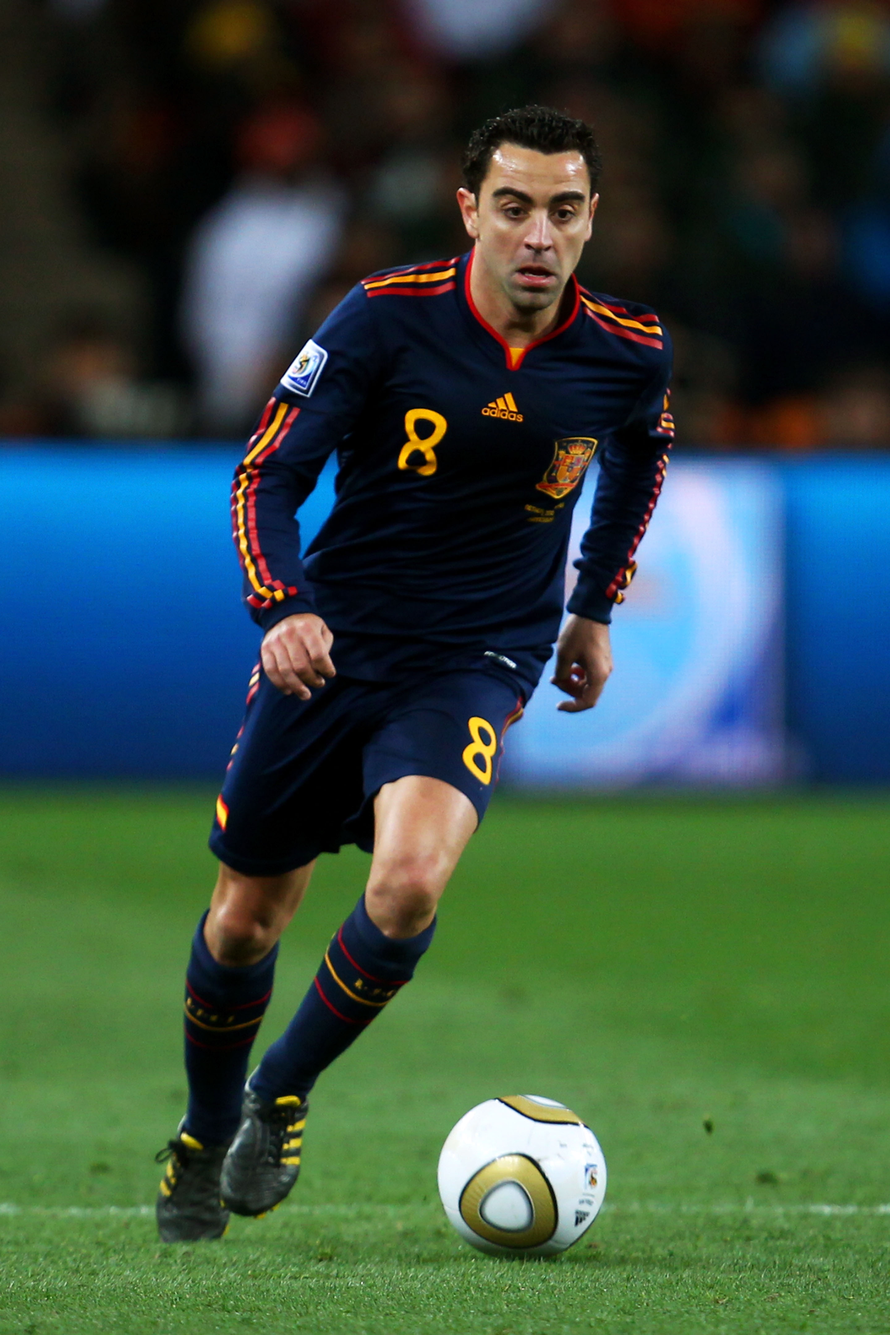 JOHANNESBURG, SOUTH AFRICA - JULY 11:  Xavi Hernandez of Spain runs with the ball during the 2010 FIFA World Cup South Africa Final match between Netherlands and Spain at Soccer City Stadium on July 11, 2010 in Johannesburg, South Africa.  (Photo by Lars