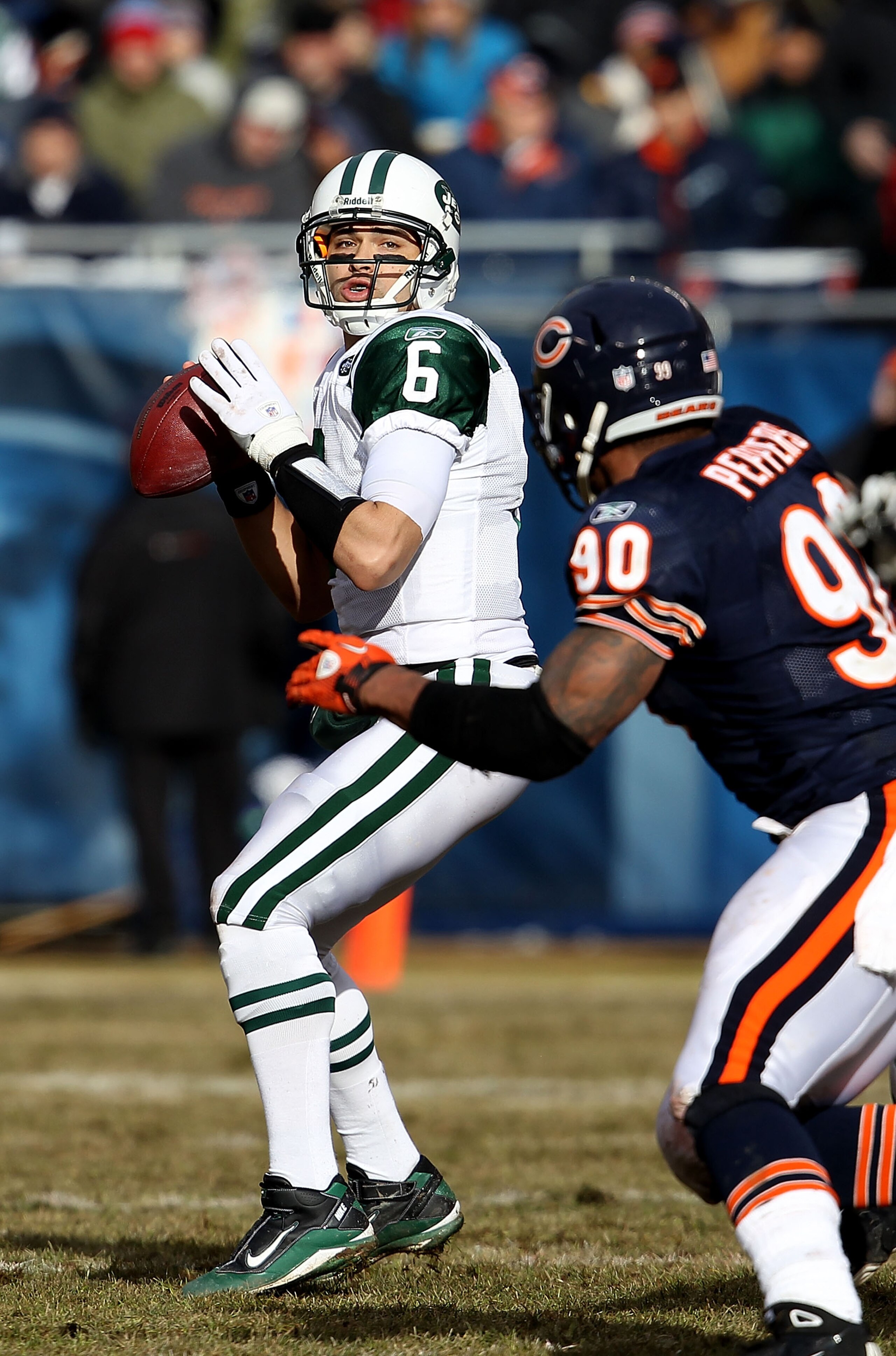 CHICAGO, IL - DECEMBER 26: Mark Sanchez #6 of the New York Jets looks for a receiver as Julius Peppers #90 of the Chicago Bears rushes at Soldier Field on December 26, 2010 in Chicago, Illinois. The Bears defeated the Jets 38-34. (Photo by Jonathan Daniel