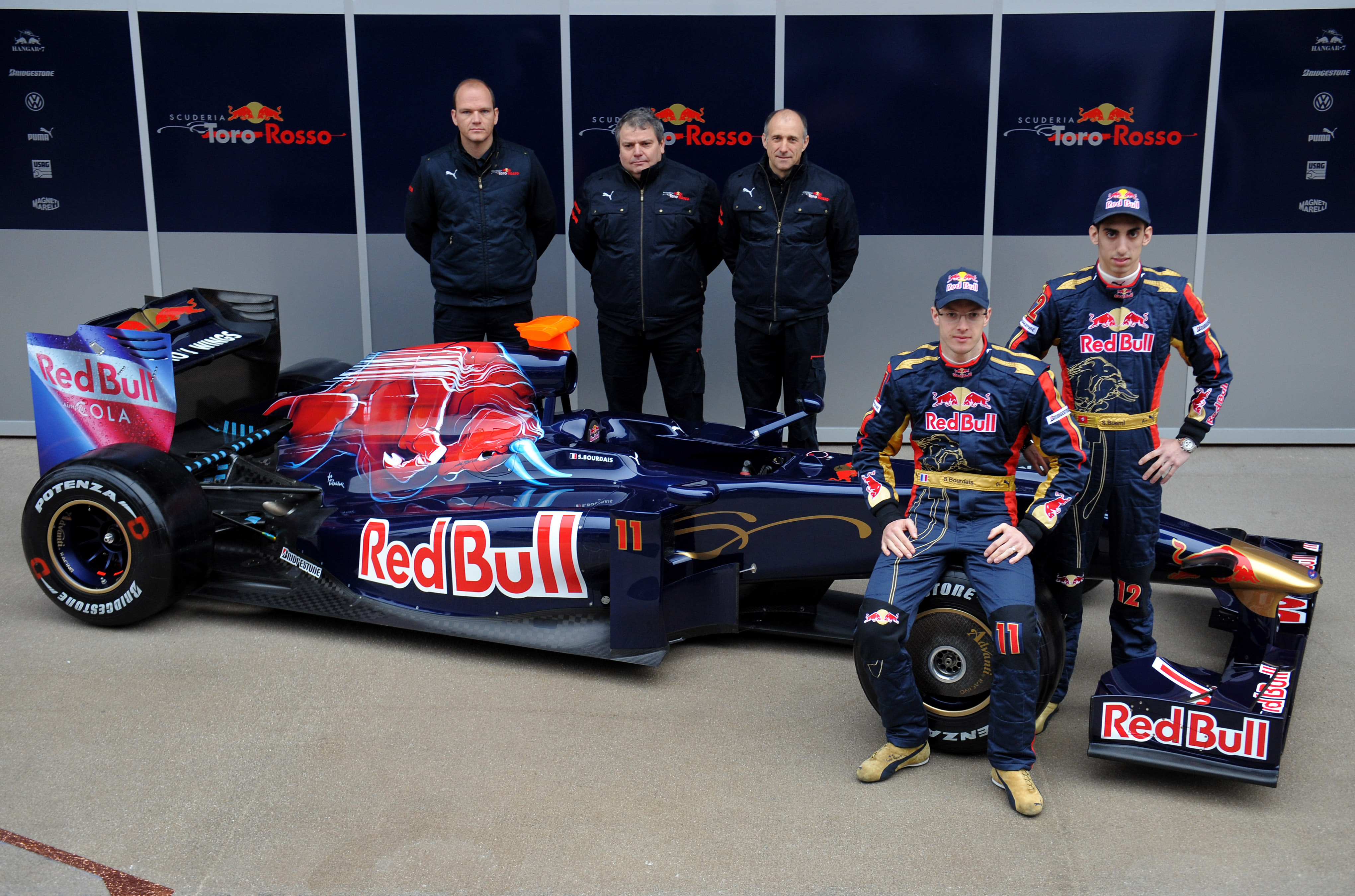 BARCELONA, SPAIN - MARCH 09:  Drivers Sebastien Bourdais (2nd R) and Sebastien Buemi (R) of team Toro Rosso pose with the team principle Franz Tost (3rd R), technical director Giorgio Ascanelli (2nd L) and Ferrari representative Ernest Knoors (L) as they