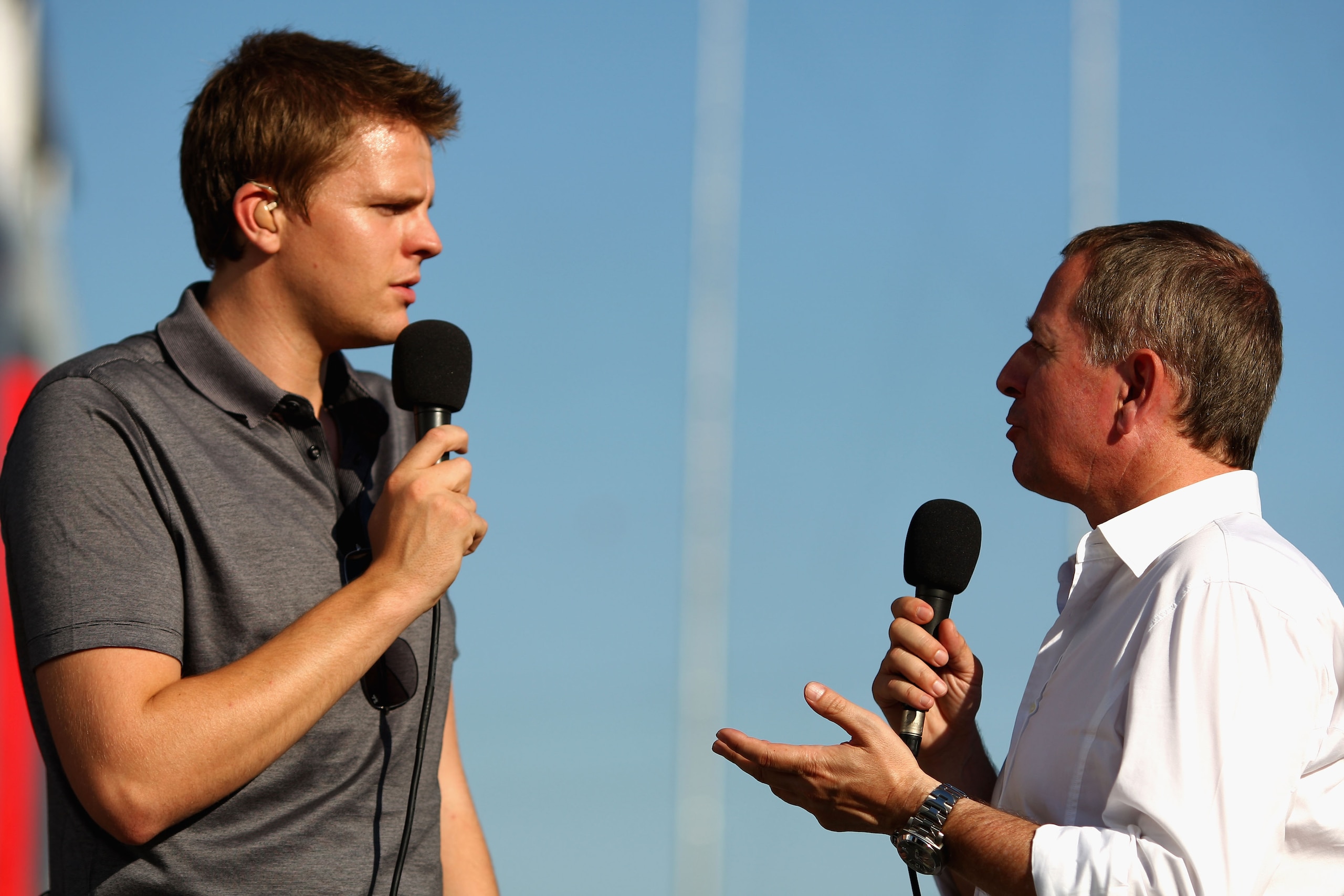 BUDAPEST, HUNGARY - JULY 24:  BBC Sport presenters Jake Humphrey (L) and Martin Brundle (R) record an interview in the paddock following practice for the Hungarian Formula One Grand Prix at the Hungaroring on July 24, 2009 in Budapest, Hungary.  (Photo by