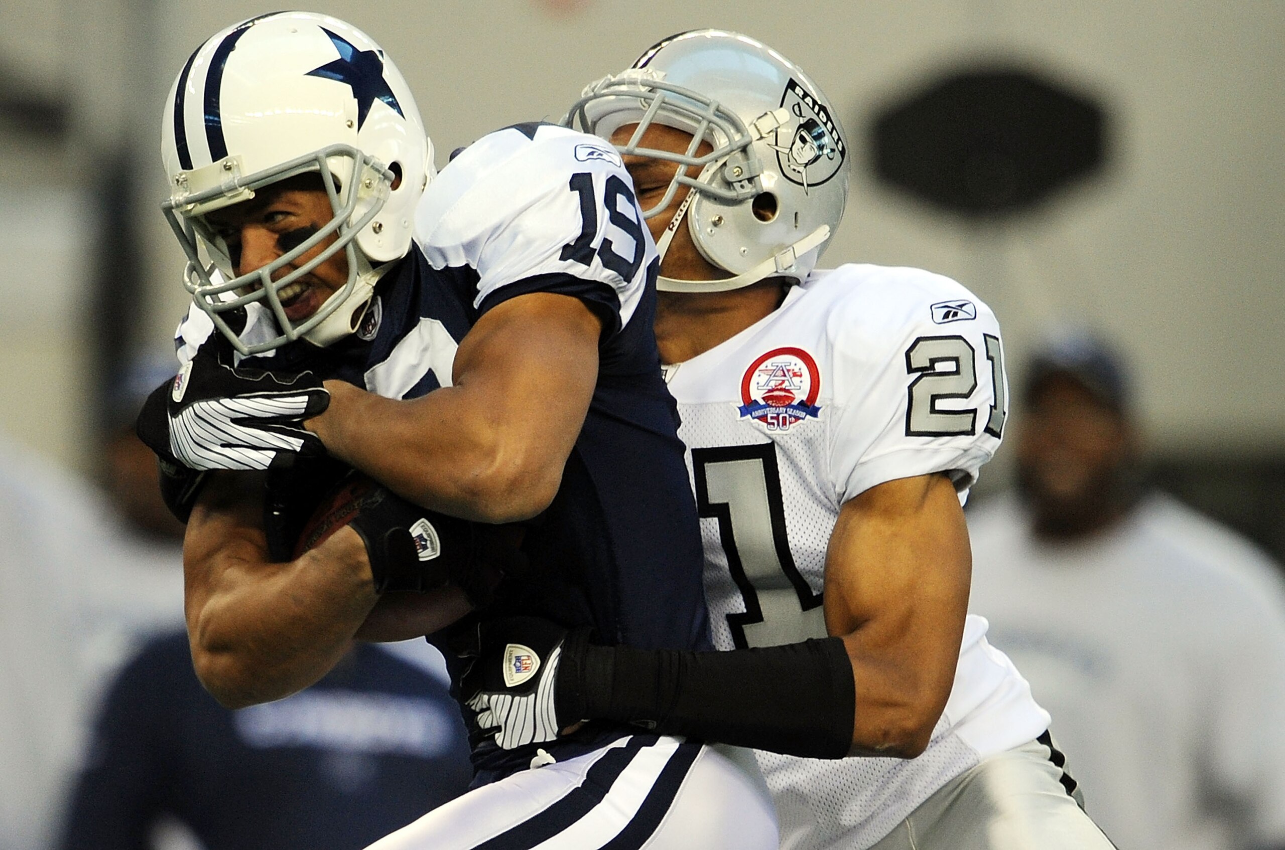 ARLINGTON, TX - NOVEMBER 26:  Wide receiver Miles Austin #19 of the Dallas Cowboys runs the ball against Nnamdi Asomugha #21 of the Oakland Raiders at Cowboys Stadium on November 26, 2009 in Arlington, Texas.  (Photo by Ronald Martinez/Getty Images)