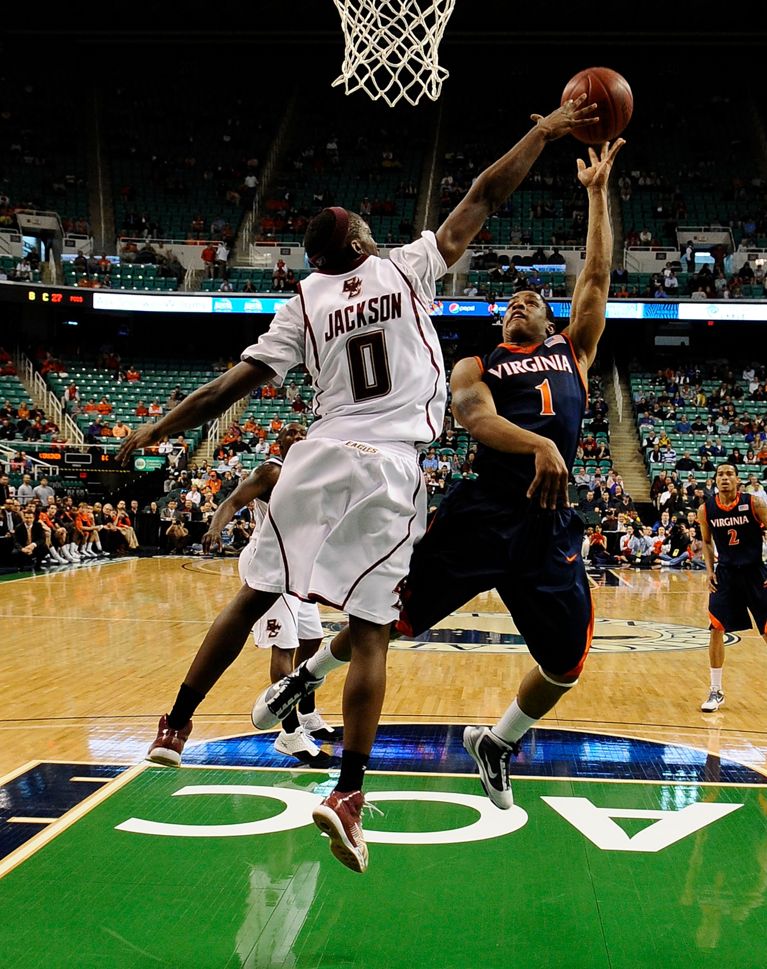 GREENSBORO, NC - MARCH 11:  Reggie Jackson #0 of the Boston College Eagles blocks a shot by Jontel Evans #1 of the University of Virginia Cavaliers in their first round game in the 2010 ACC Men's Basketball Tournament at the Greensboro Coliseum on March 1