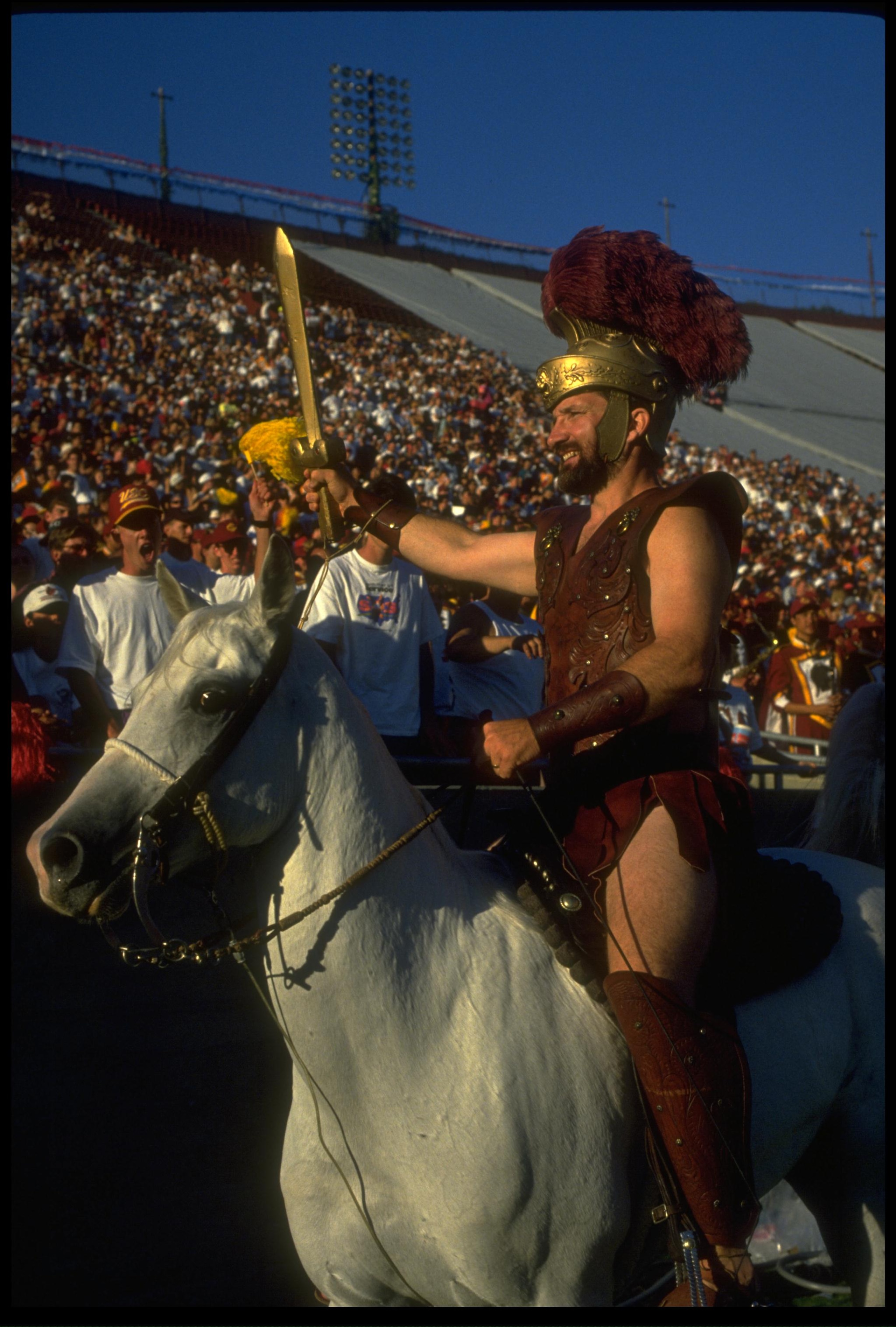 4 Sep 1993: THE USC TROJANS MASCOT TOMMY TROJAN SOLUTES THE CROWD DURING THEIR 49-7 WIN OVER THE UNIVERSITY OF HOUSTON AT THE MEMORIAL COLISEUM IN LOS ANGELES, CALIFORNIA. 4 Sep 1993: THE USC TROJANS MASCOT TOMMY TROJAN SOLUTES THE CROWD DURING THEIR 49-7 WIN OVER THE UNIVERSITY OF HOUSTON AT THE MEMORIAL COLISEUM IN LOS ANGELES, CALIFORNIA.