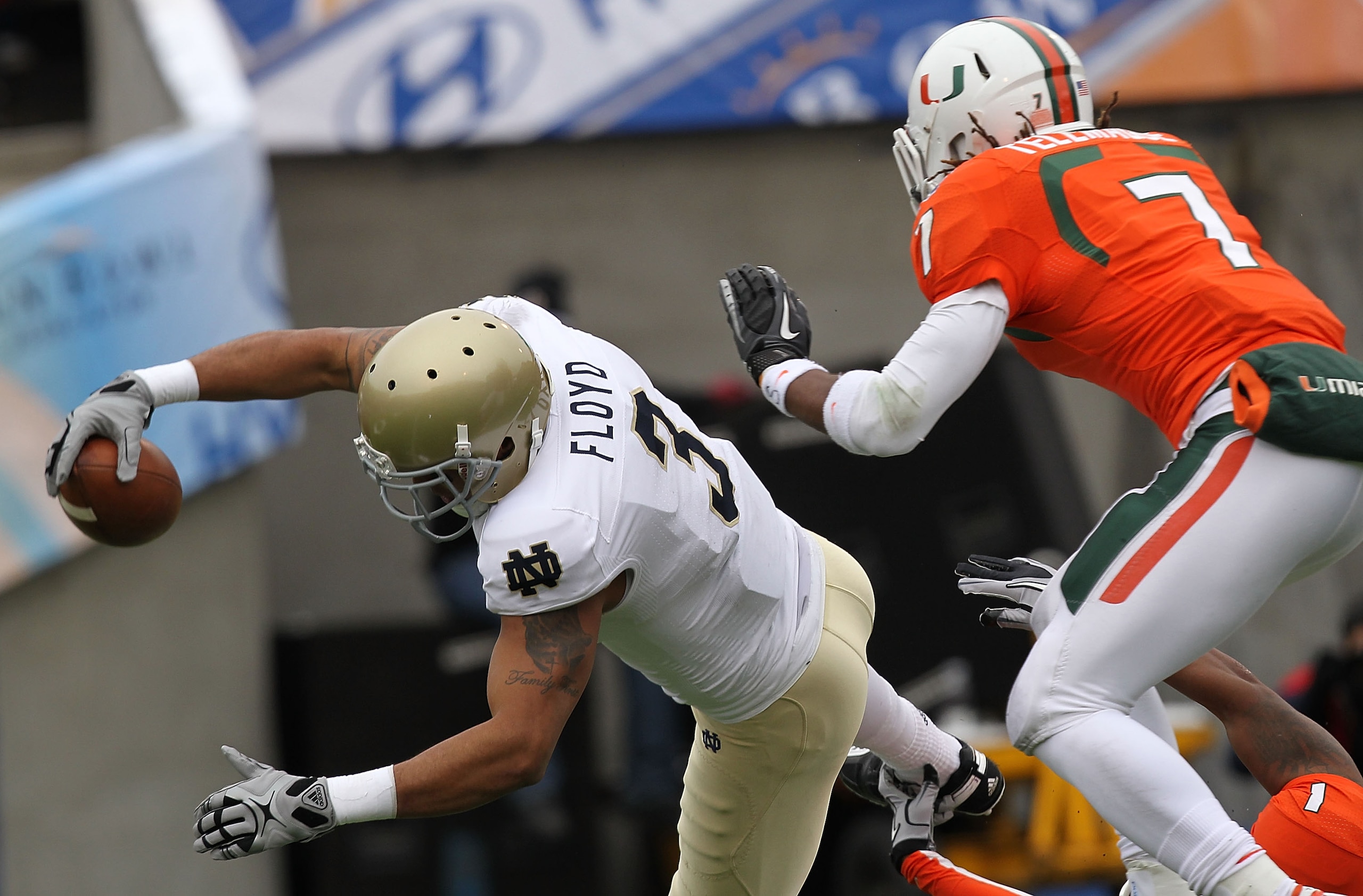 EL PASO, TX - DECEMBER 30:  Wide receiver Michael Floyd #3 of the Notre Dame Fighting Irish dives for a touchdown against Vaughn Telemaque #7 of the Miami Hurricanes at Sun Bowl on December 30, 2010 in El Paso, Texas.  (Photo by Ronald Martinez/Getty Imag
