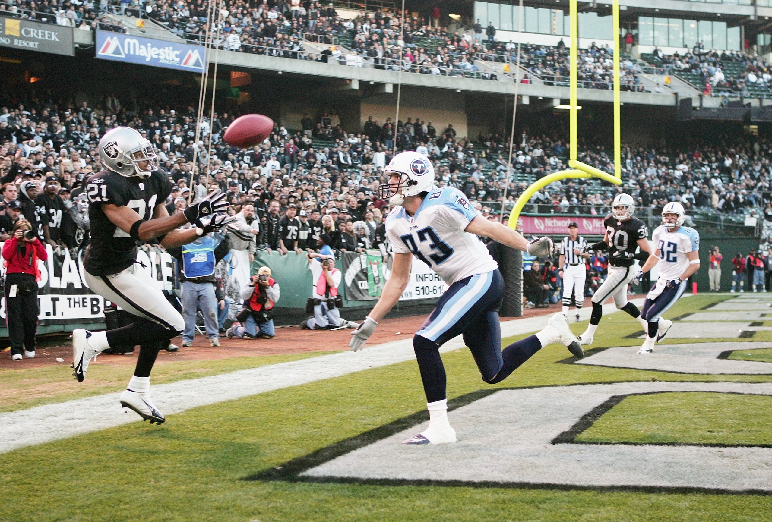 OAKLAND, CA - DECEMBER 19:  Cornerback Nnamdi Asomugha #21 of the Oakland Raiders attempts to intercept the ball in front of receiver Drew Bennett #83 of the Tennessee Titans at Network Associates Coliseum on December 19, 2004 in Oakland, California.  The