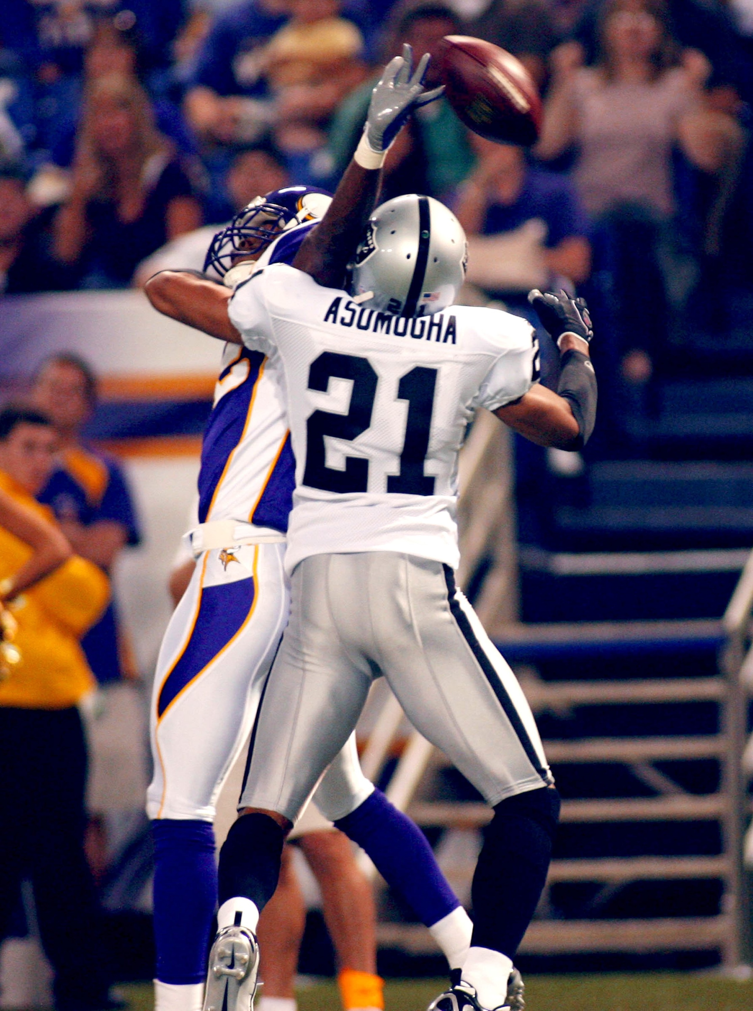 MINNEAPOLIS - AUGUST 14: Oakland Raiders' Nnamdi Asomugha #21 is charged with pass interferance against Minnesota Vikings' Troy Williamson #82 in the first quarter of the Monday night game Monday August 14, 2006 at the Hubert H. Humphrey Metrodome in Minn