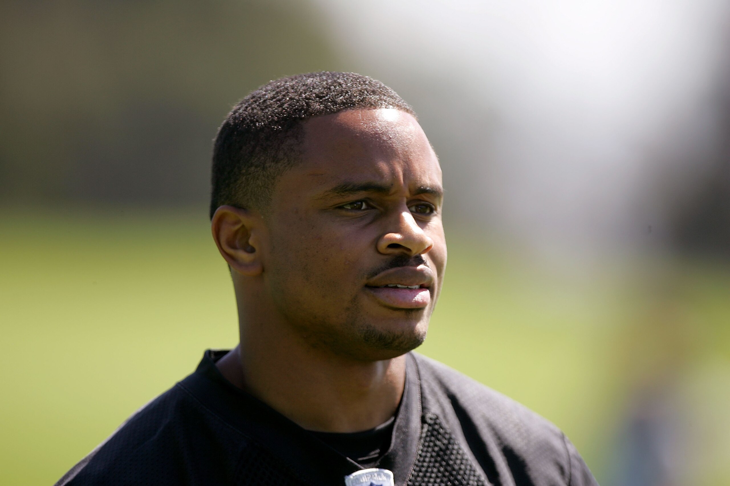ALAMEDA, CA - MAY 08:  Nnamdi Asomugha #21 of the Oakland Raiders watches practice from the sideline during the Raiders minicamp at the team's permanent training facility on May 8, 2009 in Alameda, California.  (Photo by Ezra Shaw/Getty Images)