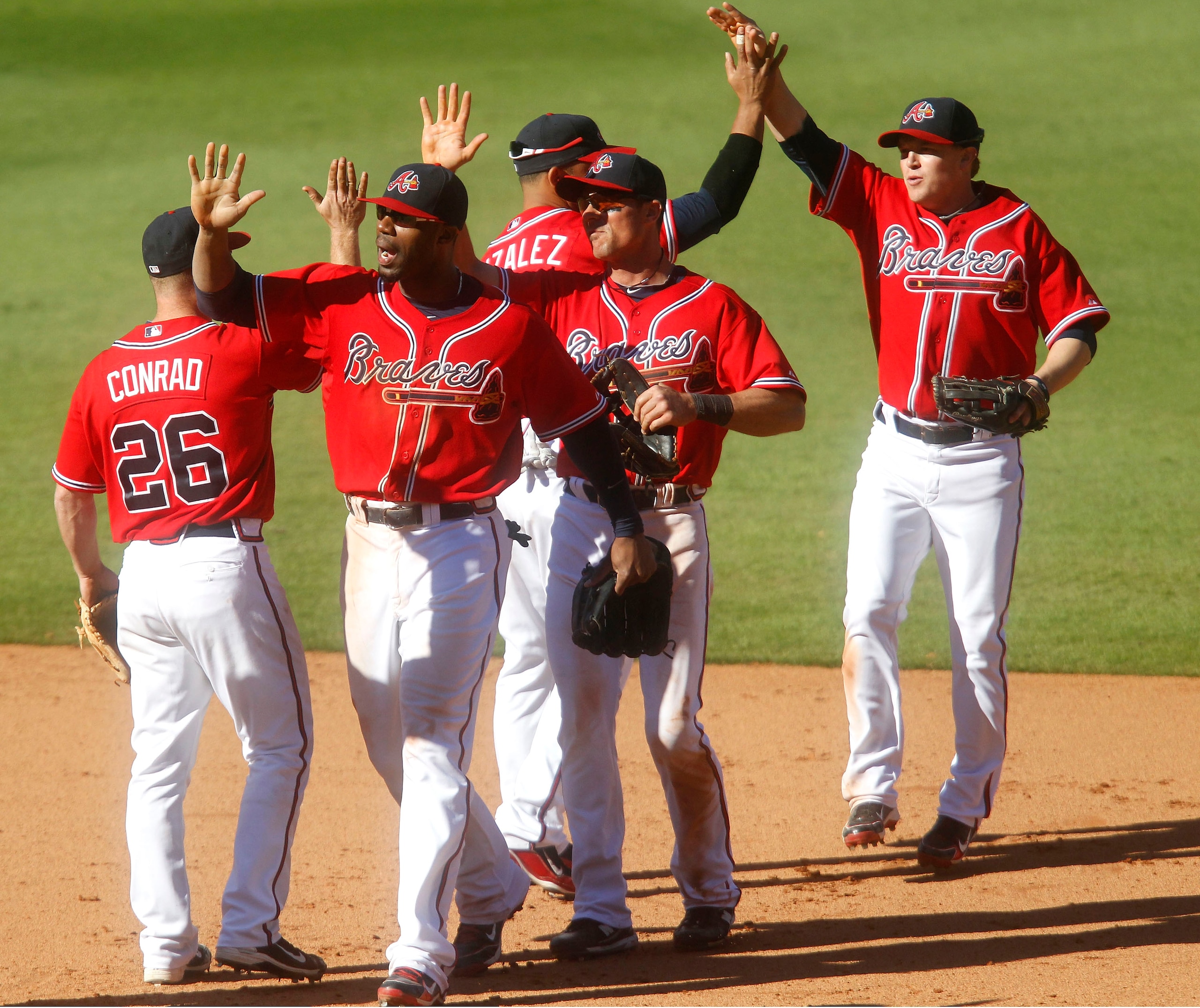 ATLANTA - OCTOBER 3:  (L-R) Teammates Brooks Conrad #26, Jason Heyward #22, Alex Gonzalez #2, Rick Ankiel #28 and Nate McLouth #24 of the Atlanta Braves celebrate the last out after the game against the Philadelphia Phillies at Turner Field on October 3,