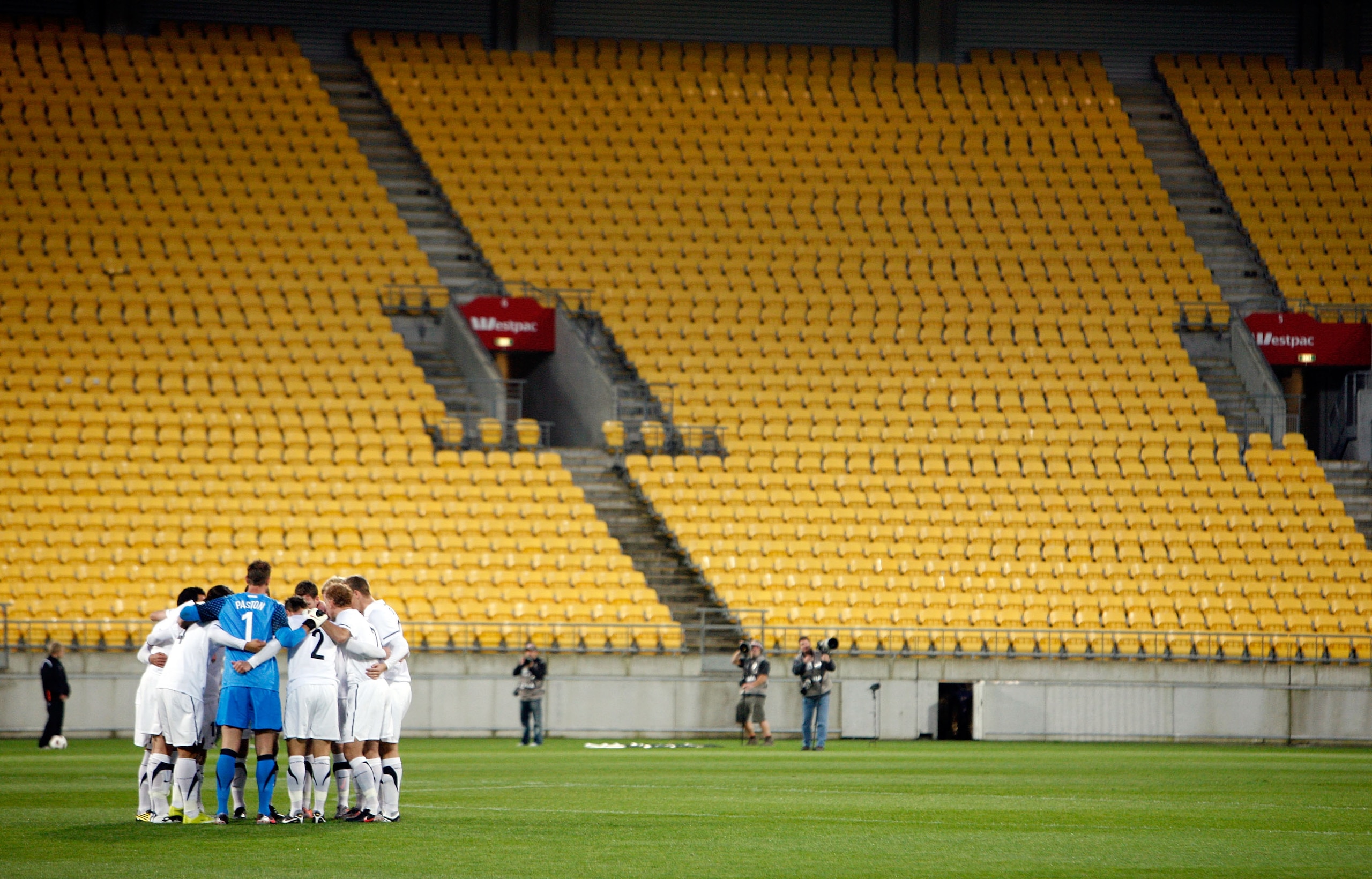WELLINGTON, NEW ZEALAND - OCTOBER 12:  The All Whites form a huddle in front of empty stands during the International Friendly match between the New Zealand All Whites and Paraguay at Westpac Stadium on October 12, 2010 in Wellington, New Zealand.  (Photo