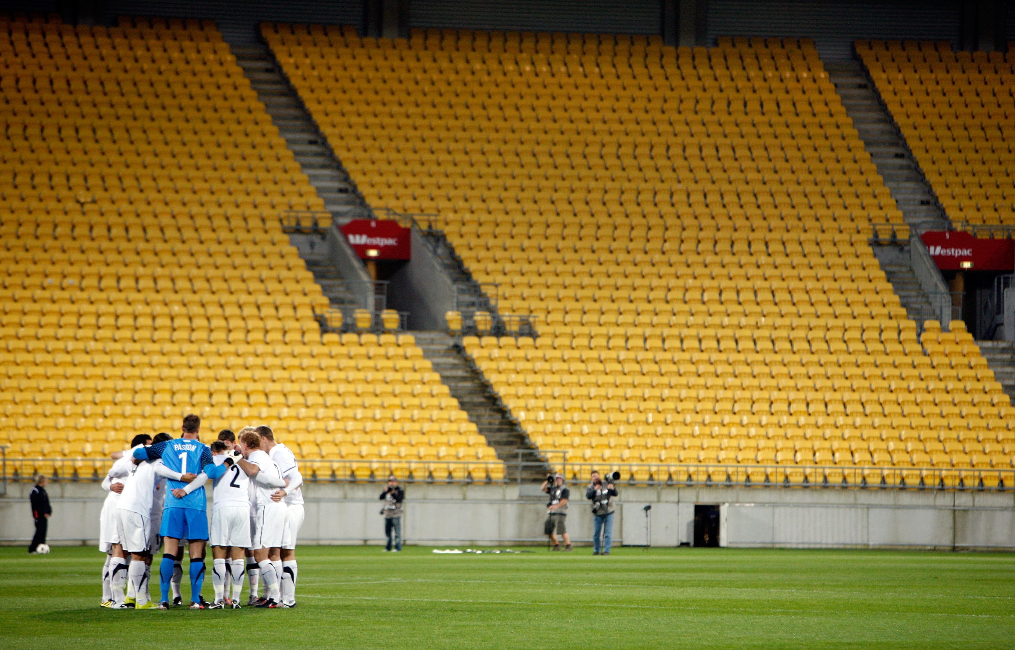 WELLINGTON, NEW ZEALAND - OCTOBER 12:  The All Whites form a huddle in front of empty stands during the International Friendly match between the New Zealand All Whites and Paraguay at Westpac Stadium on October 12, 2010 in Wellington, New Zealand.  (Photo