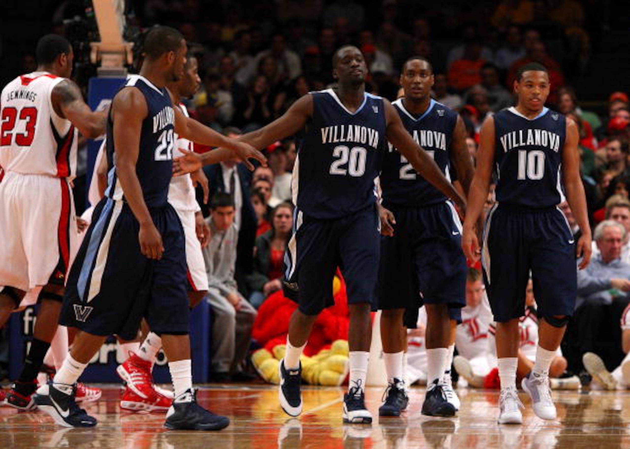 NEW YORK - MARCH 13: Dwayne Anderson #22, Shane Clark #20, Corey Stokes #24 and Corey Fisher #10 of the Villanova Wildcats react between plays against the Louisville Cardinals during the semifinal round of the Big East Tournament at Madison Square Garden