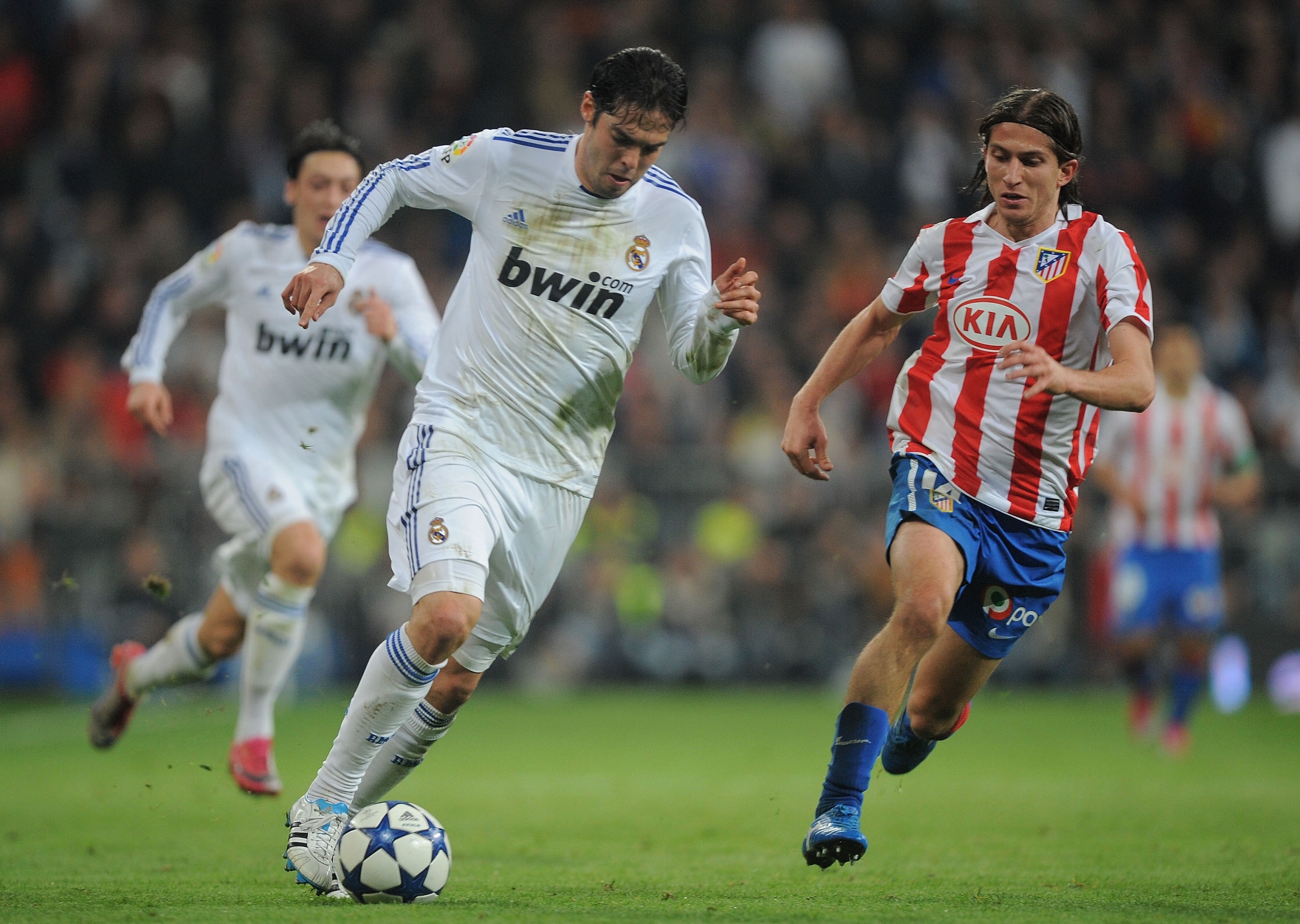 MADRID, SPAIN - JANUARY 13: Kaka (L) of Real Madrid tries to get past Felipe of Atletico Madrid during the Copa del Rey quarter final first leg match between Real Madrid and Atletico Madrid at Estadio Santiago Bernabeu on January 13, 2011 in Madrid, Spain