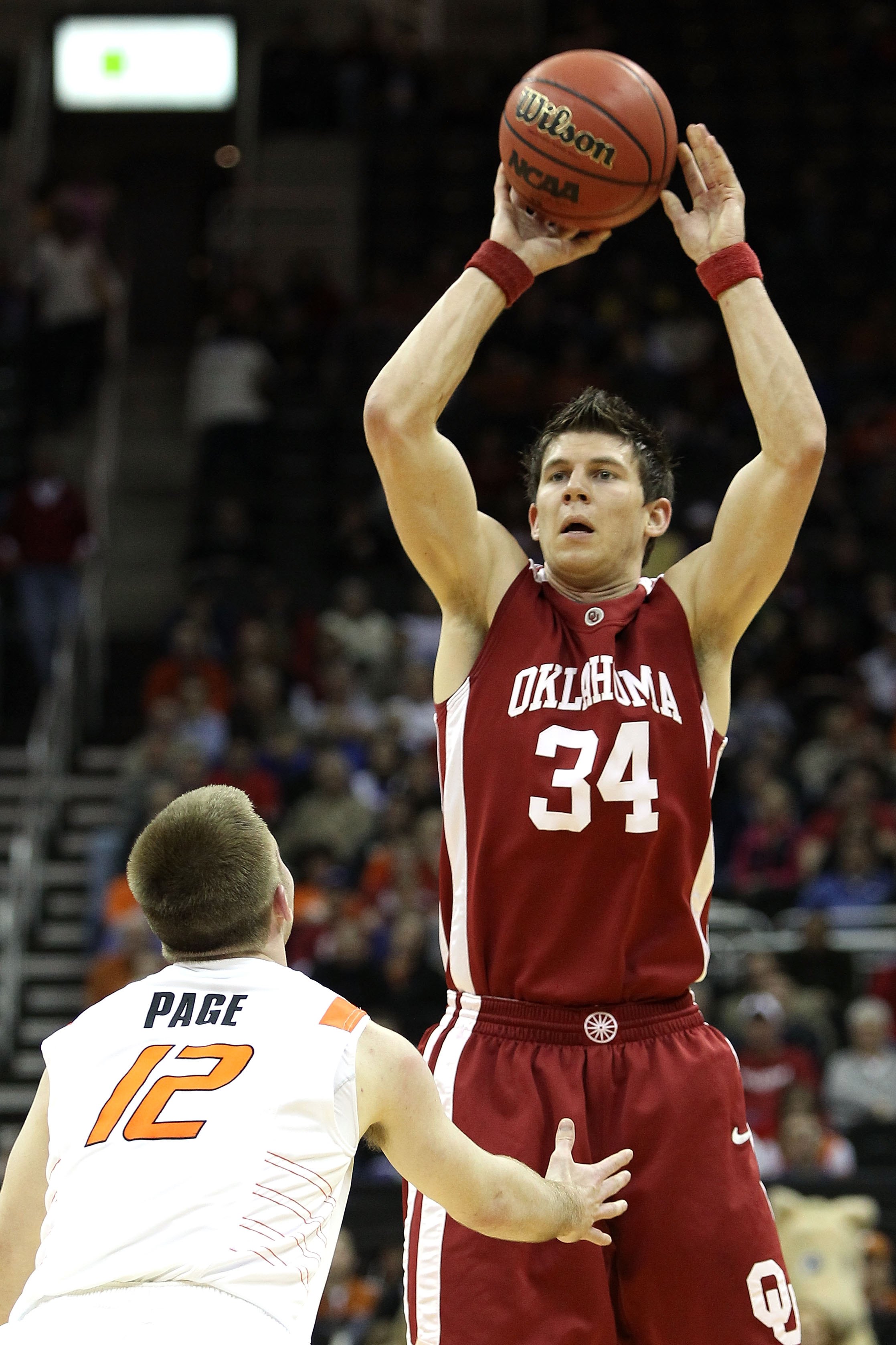 KANSAS CITY, MO - MARCH 10: Cade Davis #34 of the Oklahoma Sooners moves the ball as he is covered by Keiton Page #12 of the Oklahoma State Cowboys during the first round game of the 2010 Phillips 66 Big 12 Men's Basketball Tournament at the Sprint Cente