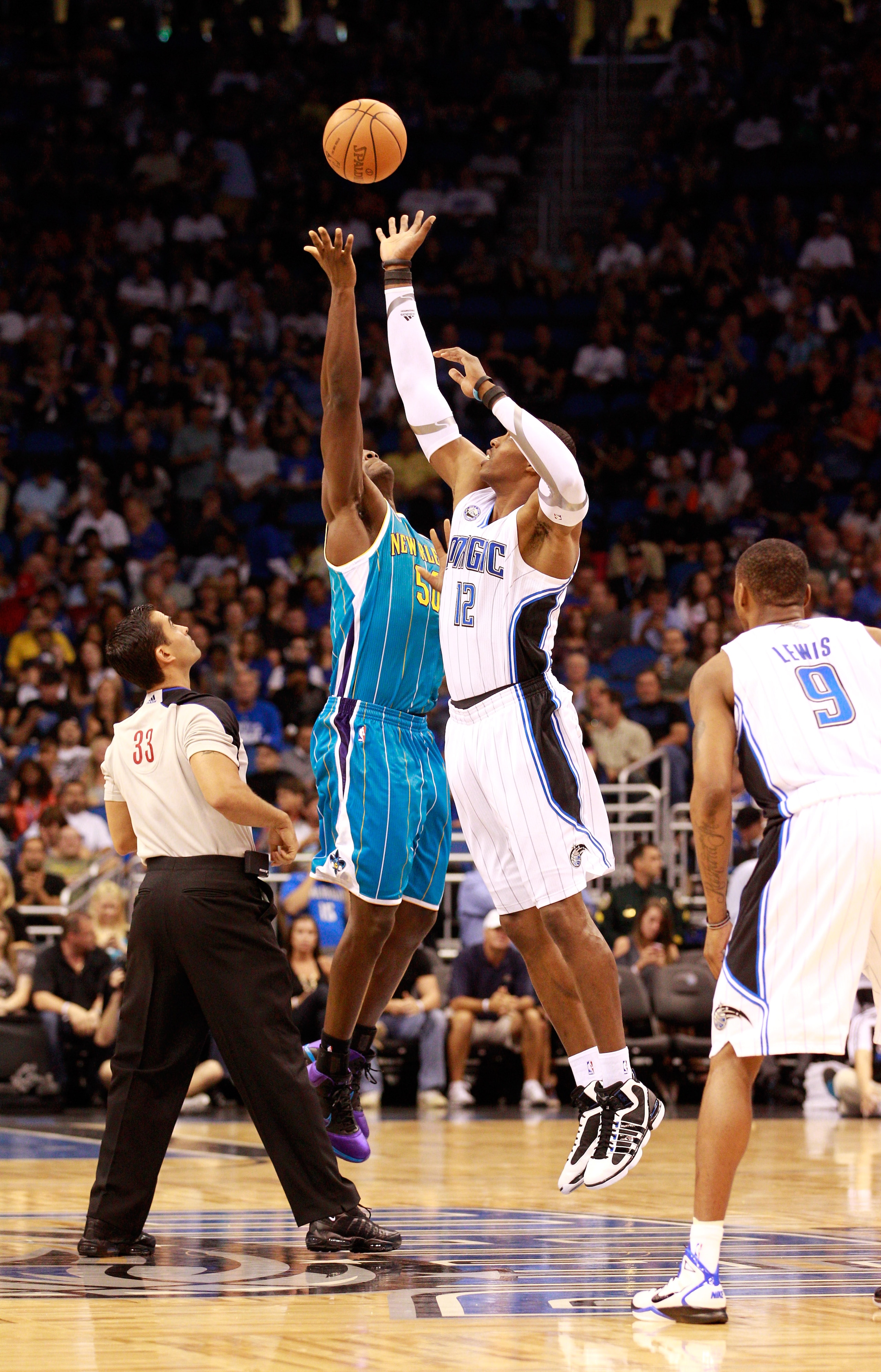 ORLANDO, FL - OCTOBER 10:  Dwight Howard #12 of the Orlando Magic jumps against  Emeka Okafor #50 of the New Orleans Hornets during the game at Amway Arena on October 10, 2010 in Orlando, Florida. NOTE TO USER: User expressly acknowledges and agrees that,