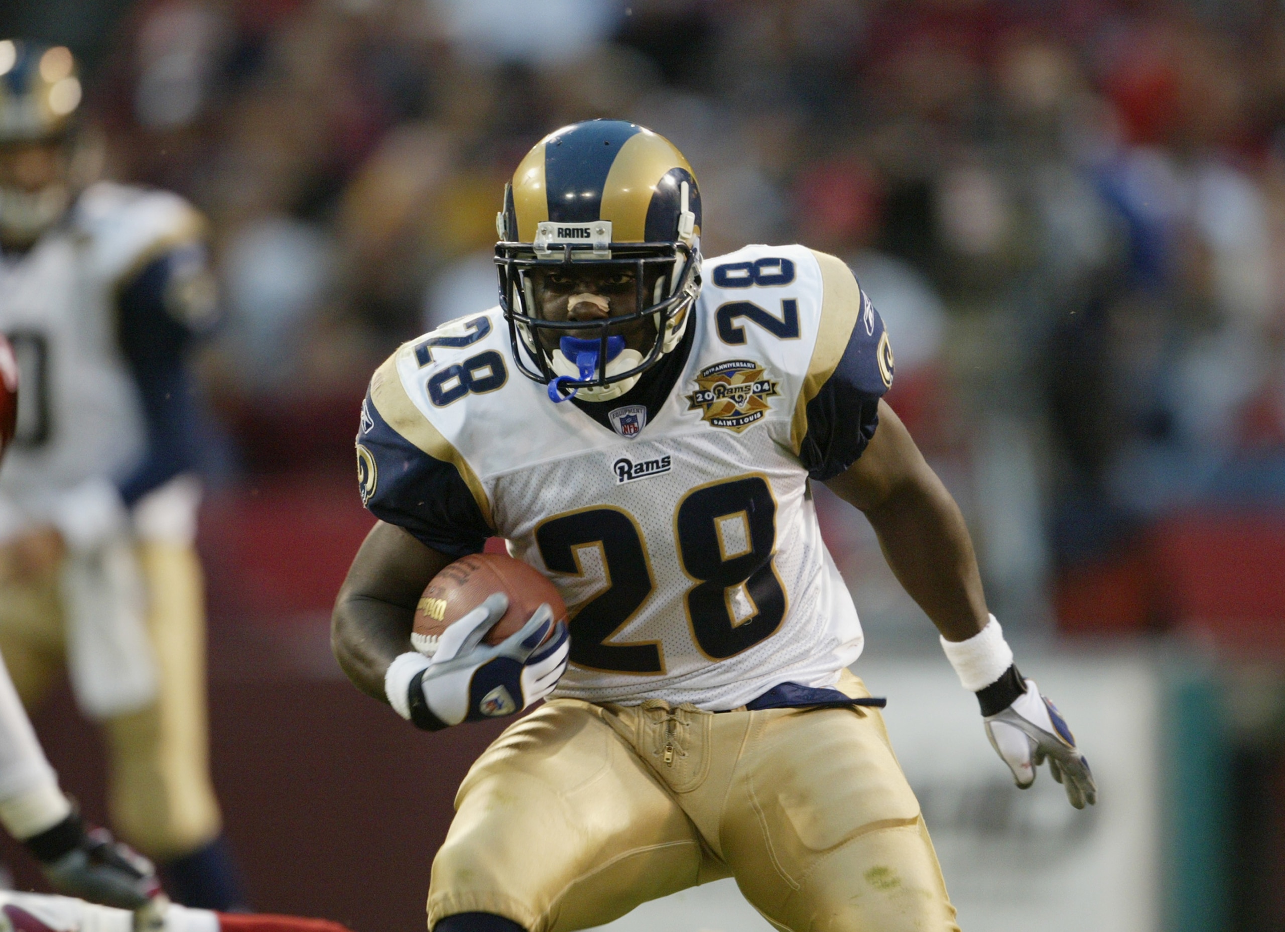 SAN FRANCISCO - OCTOBER 3:  Running back Marshall Faulk #28 of the St. Louis Rams carries the ball against the San Francisco 49ers during the game at Monster Park on October 3, 2004 in San Francisco, California. The Rams defeated the 49ers 24-12. (Photo b