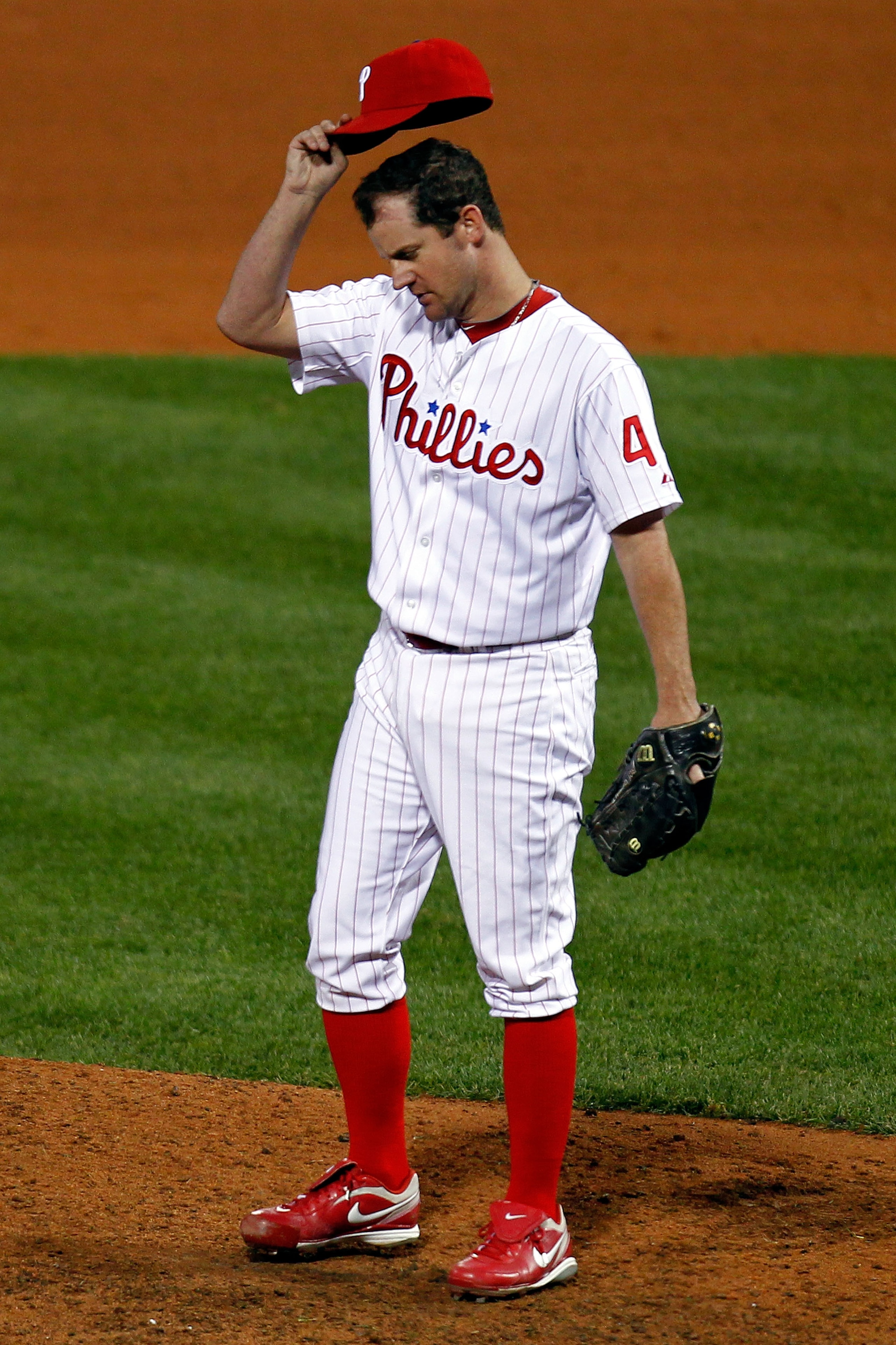 PHILADELPHIA - OCTOBER 23:  Roy Oswalt #44 of the Philadelphia Phillies adjusts his hat while playing against the San Francisco Giants in Game Six of the NLCS during the 2010 MLB Playoffs at Citizens Bank Park on October 23, 2010 in Philadelphia, Pennsylv