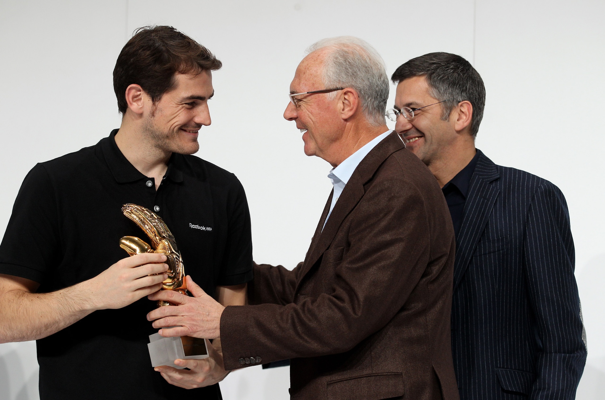 HERZOGENAURACH, GERMANY - DECEMBER 14: Herbert Hainer (R), the adidas Group CEO, and FIFA executive committee member Franz Beckenbauer (C) hand over the adidas Golden Glove to Iker Casillas (L) during the FIFA 2010 World Cup adidas Golden Award ceremony HERZOGENAURACH, GERMANY - DECEMBER 14: Herbert Hainer (R), the adidas Group CEO, and FIFA executive committee member Franz Beckenbauer (C) hand over the adidas Golden Glove to Iker Casillas (L) during the FIFA 2010 World Cup adidas Golden Award ceremony