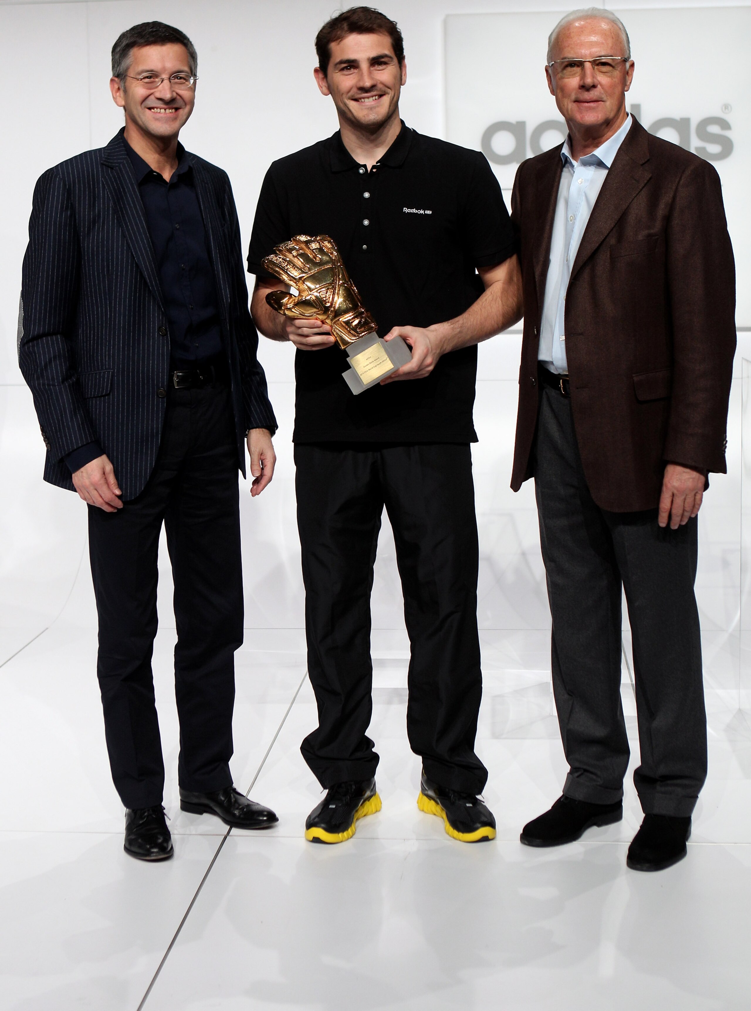 HERZOGENAURACH, GERMANY - DECEMBER 14: (L-R) Herbert Hainer, the adidas Group CEO, Iker Casillas, adidas Golden Glove Winner and FIFA executive committee member Franz Beckenbauer pose during the FIFA 2010 World Cup adidas Golden Award ceremony at the adi HERZOGENAURACH, GERMANY - DECEMBER 14: (L-R) Herbert Hainer, the adidas Group CEO, Iker Casillas, adidas Golden Glove Winner and FIFA executive committee member Franz Beckenbauer pose during the FIFA 2010 World Cup adidas Golden Award ceremony at the adi