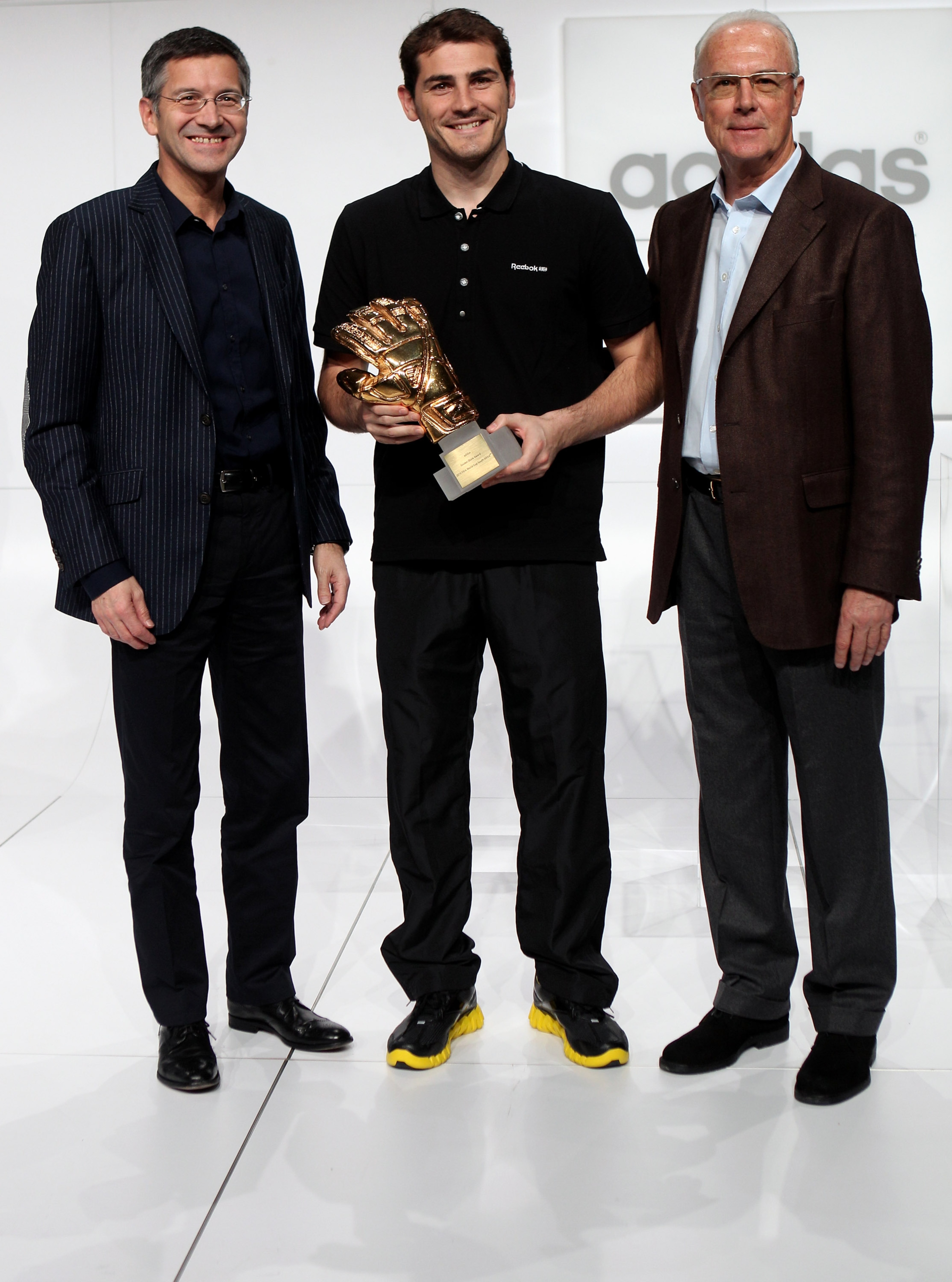 HERZOGENAURACH, GERMANY - DECEMBER 14:  (L-R) Herbert Hainer, the adidas Group CEO, Iker Casillas, adidas Golden Glove Winner and FIFA executive committee member Franz Beckenbauer pose during the FIFA 2010 World Cup adidas Golden Award ceremony at the adi
