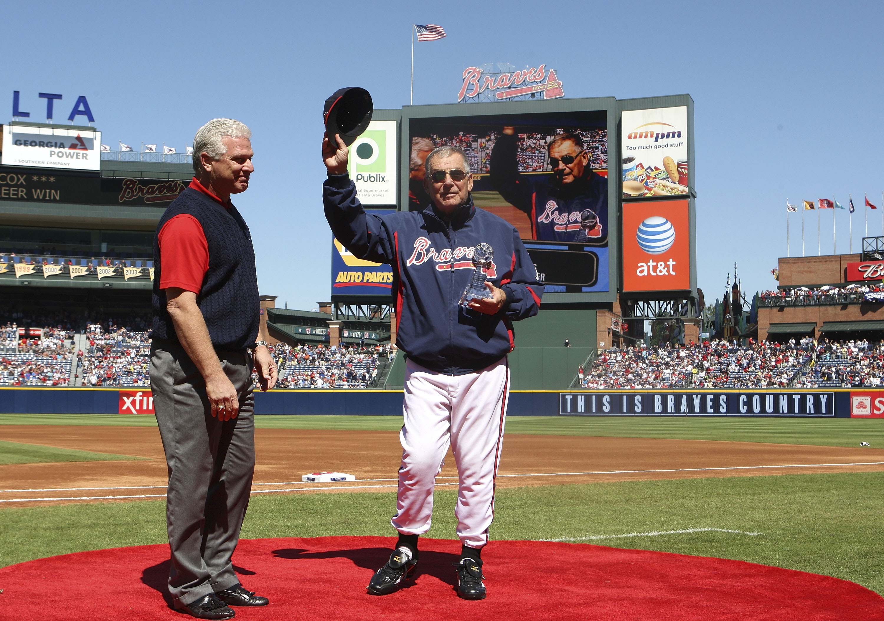 ATLANTA - OCTOBER 3:  Manager Bobby Cox #6 of the Atlanta Braves receives a trophy commenmorating his 2,500th win from general manager Frank Wren (L) before the game against the Philadelphia Phillies at Turner Field on October 3, 2010 in Atlanta, Georgia.