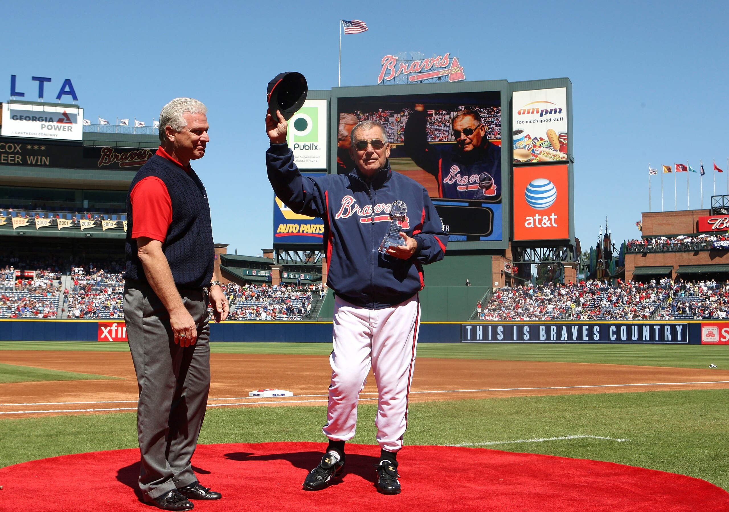 ATLANTA - OCTOBER 3:  Manager Bobby Cox #6 of the Atlanta Braves receives a trophy commenmorating his 2,500th win from general manager Frank Wren (L) before the game against the Philadelphia Phillies at Turner Field on October 3, 2010 in Atlanta, Georgia.