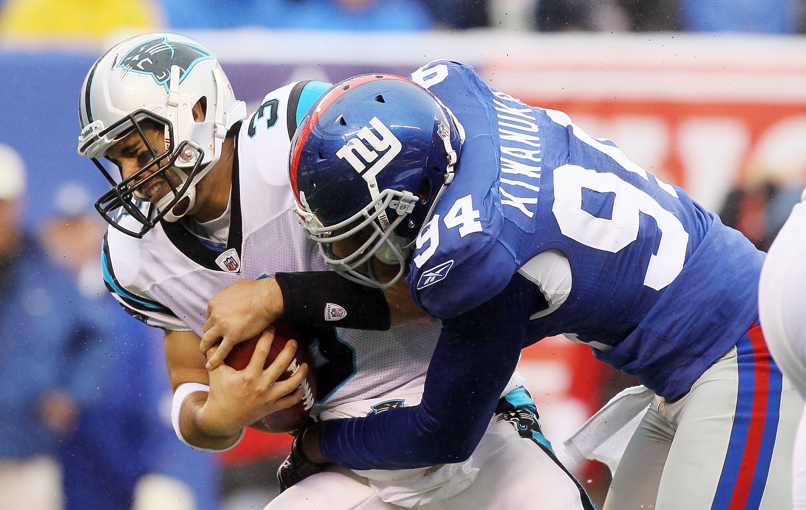 EAST RUTHERFORD, NJ - SEPTEMBER 12:  Matt Moore #3 of the Carolina Panthers is sacked in the fourth quarter by Mathias Kiwanuka #94 of the New York Giants on September 12, 2010 at the New Meadowlands Stadium in East Rutherford, New Jersey. The Giants defe