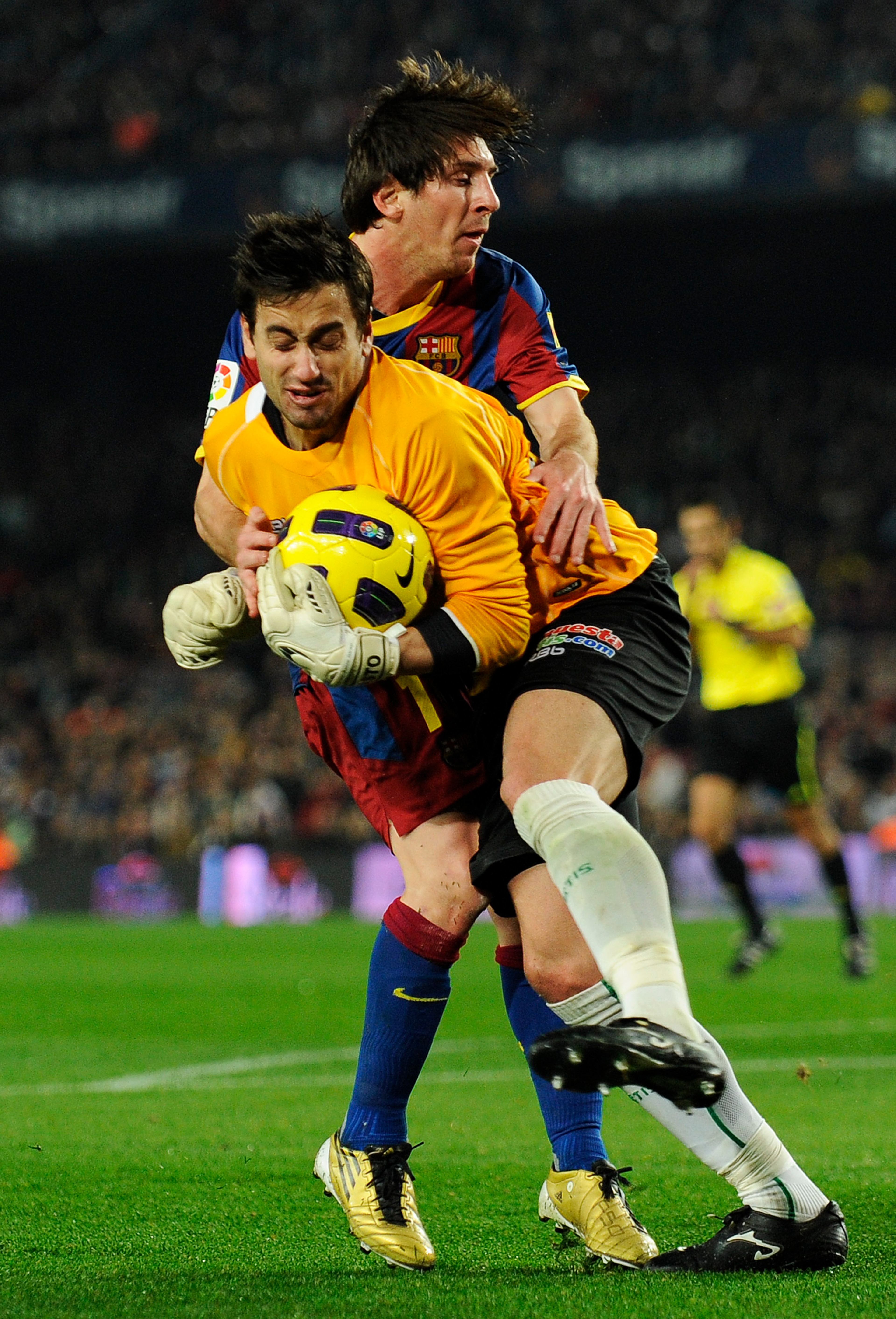 BARCELONA, SPAIN - JANUARY 12:  Lionel Messi of FC Barcelona (L) duels for the ball agains Casto of Betis during the Copa del Rey quarter final first leg match FC Barcelona and Betis at Camp Nou on January 12, 2011 in Barcelona, Spain. Barcelona won 5-0.
