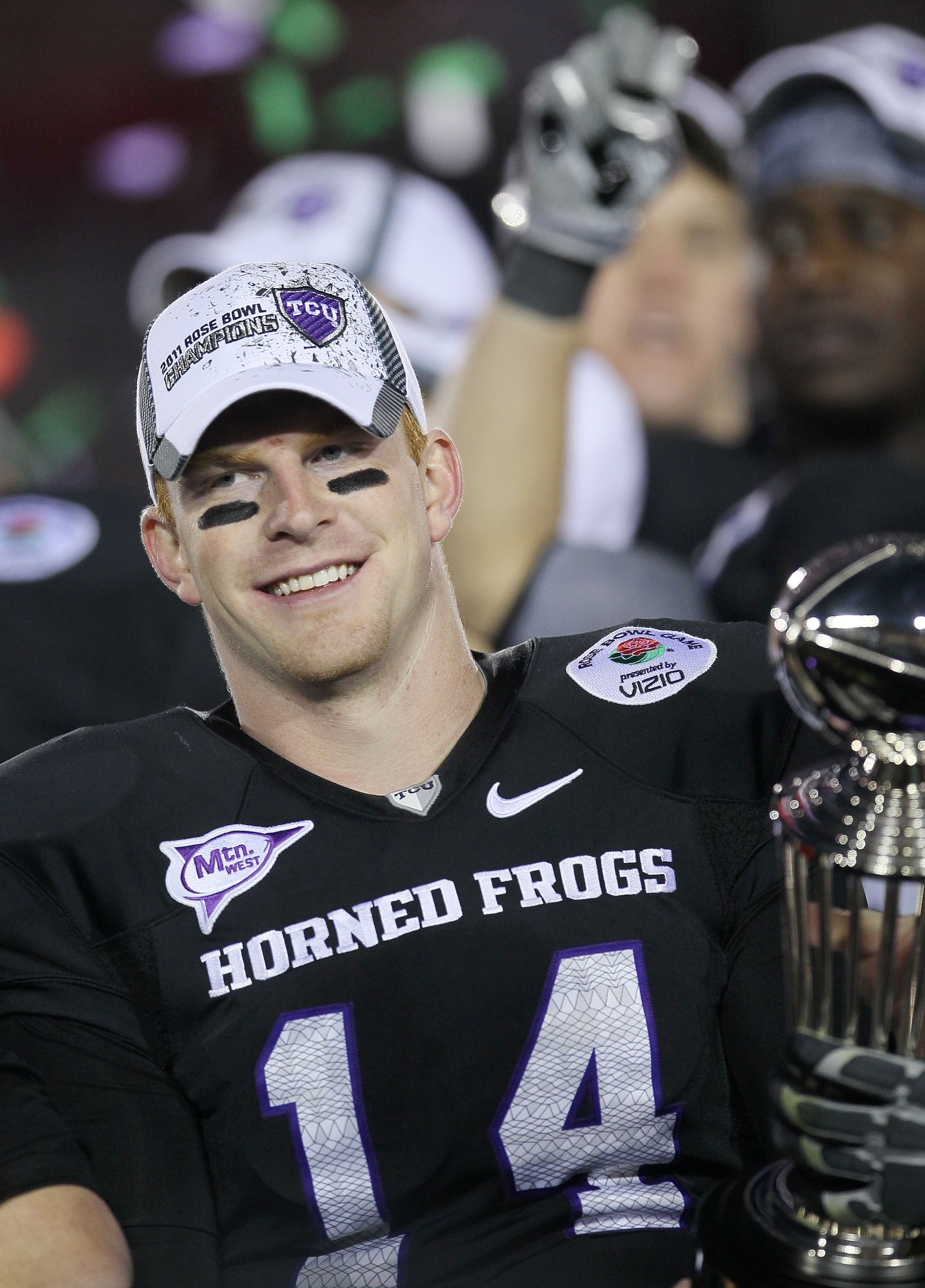 PASADENA, CA - JANUARY 01:  Quarterback Andy Dalton #14 of the TCU Horned Frogs celebrates with the Rose Bowl Championship Trophy after defeating the Wisconsin Badgers 21-19 in the 97th Rose Bowl game on January 1, 2011 in Pasadena, California.  (Photo by