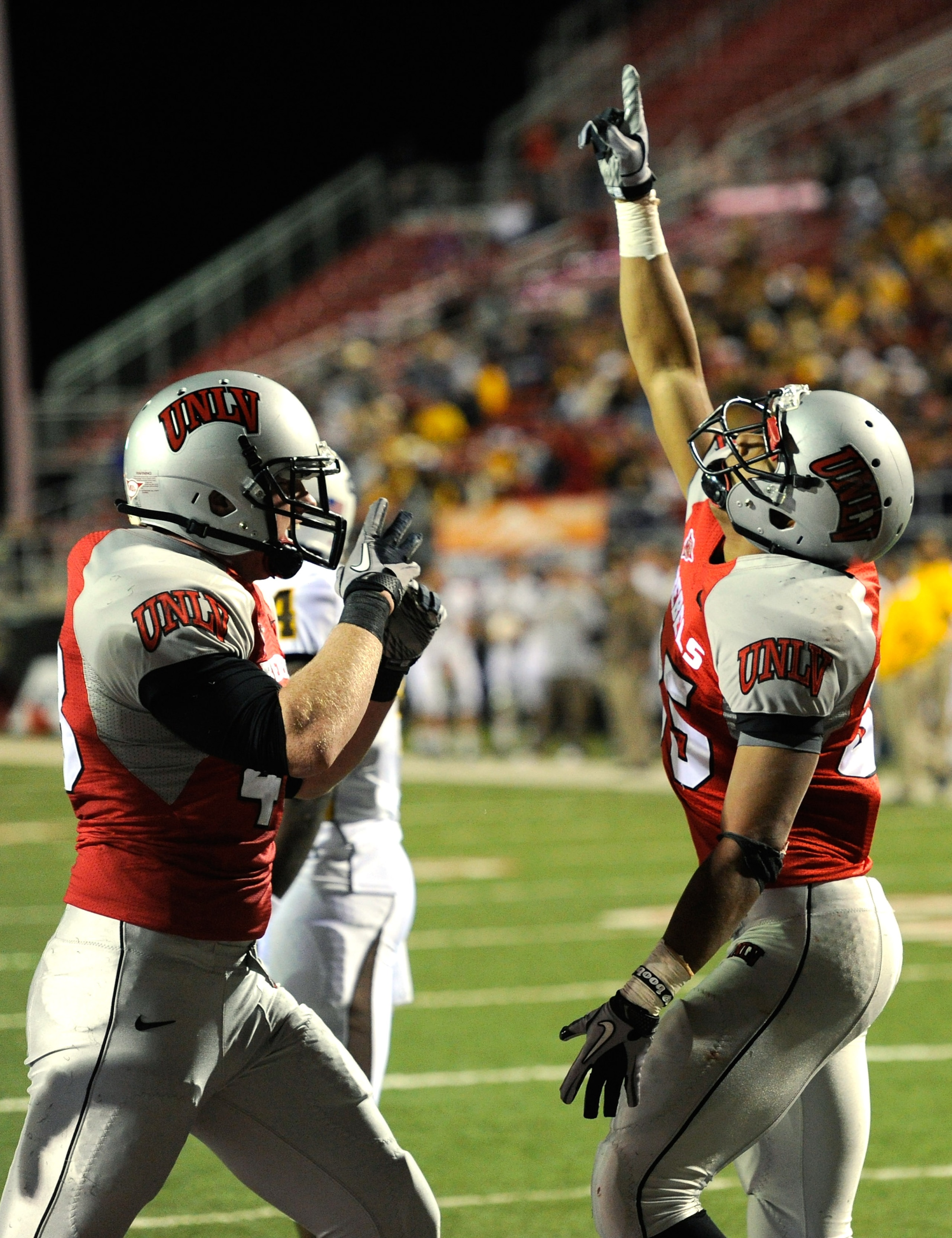 LAS VEGAS - NOVEMBER 13:  Beau Brence (L) #48 and Tim Cornett #35 of the UNLV Rebels celebrate after Cornett scored a touchdown against the Wyoming Cowboys during their game at Sam Boyd Stadium November 13, 2010 in Las Vegas, Nevada.  (Photo by Ethan Mill
