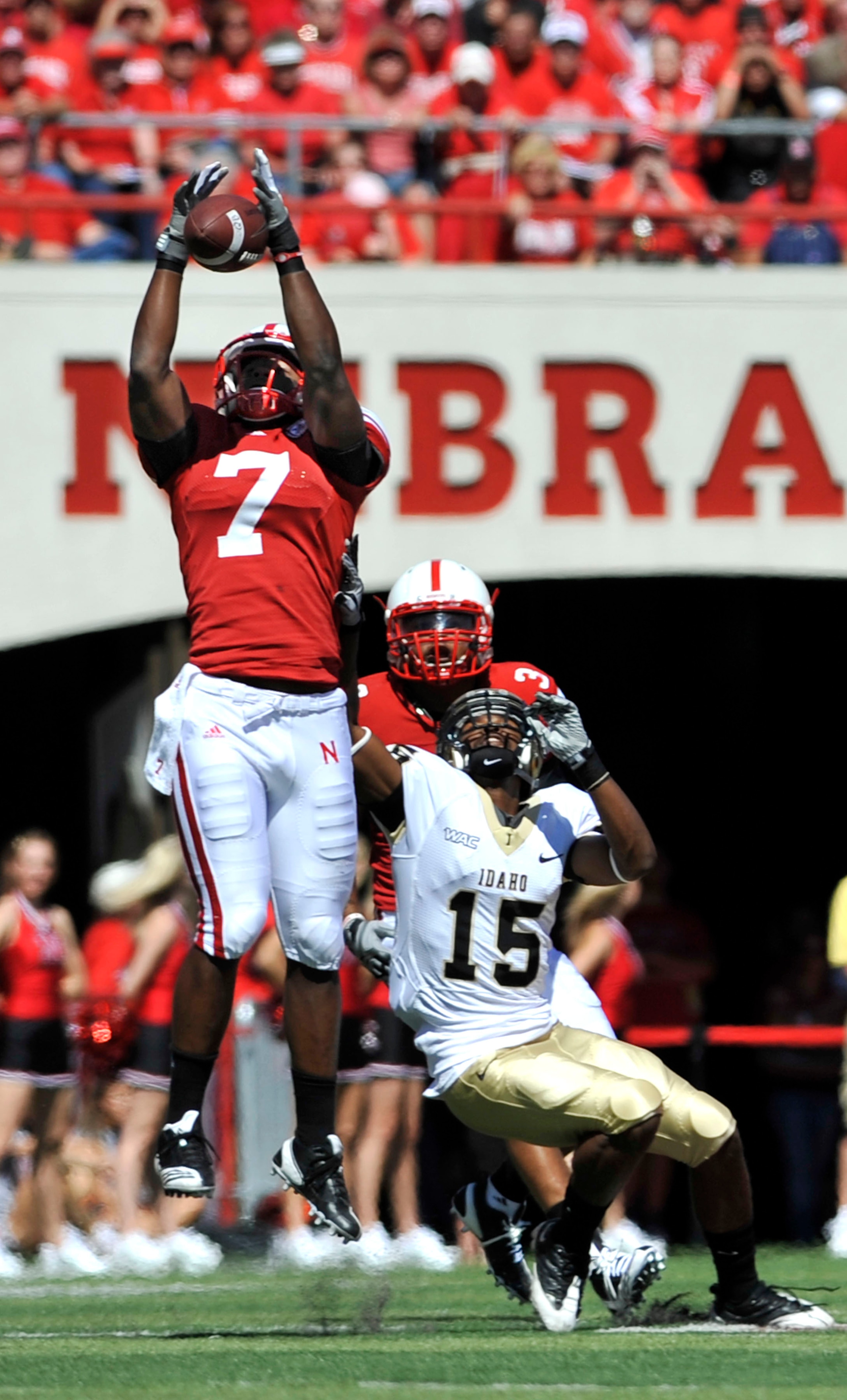 LINCOLN, NEBRASKA - SEPTEMBER 11: Nebraska Cornhuskers defensive back DeJon Gomes #7 and safety Rickey Thenarse #3 knock a pass away from Idaho Vandals wide receiver Marsel Posey #15 during first half action of their game at Memorial Stadium on September
