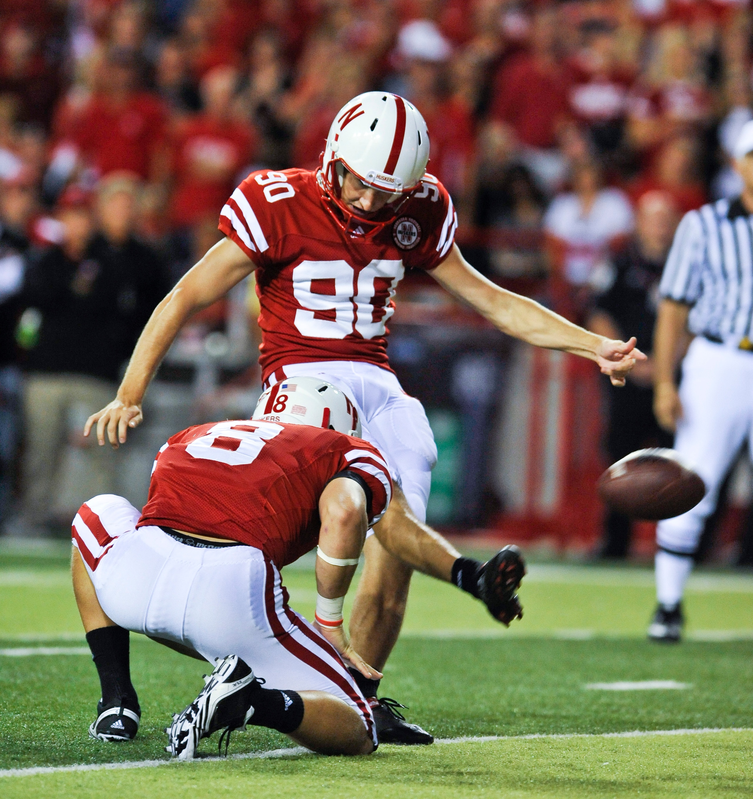 LINCOLN, NE - SEPTEMBER 04: Alex Henry #90 of the Nebraska Cornhuskers  kicks an extra point against the Western Kentucky Hilltoppers  during second half action of their game at Memorial Stadium on September 4, 2010 in Lincoln, Nebraska. Nebraska defeated