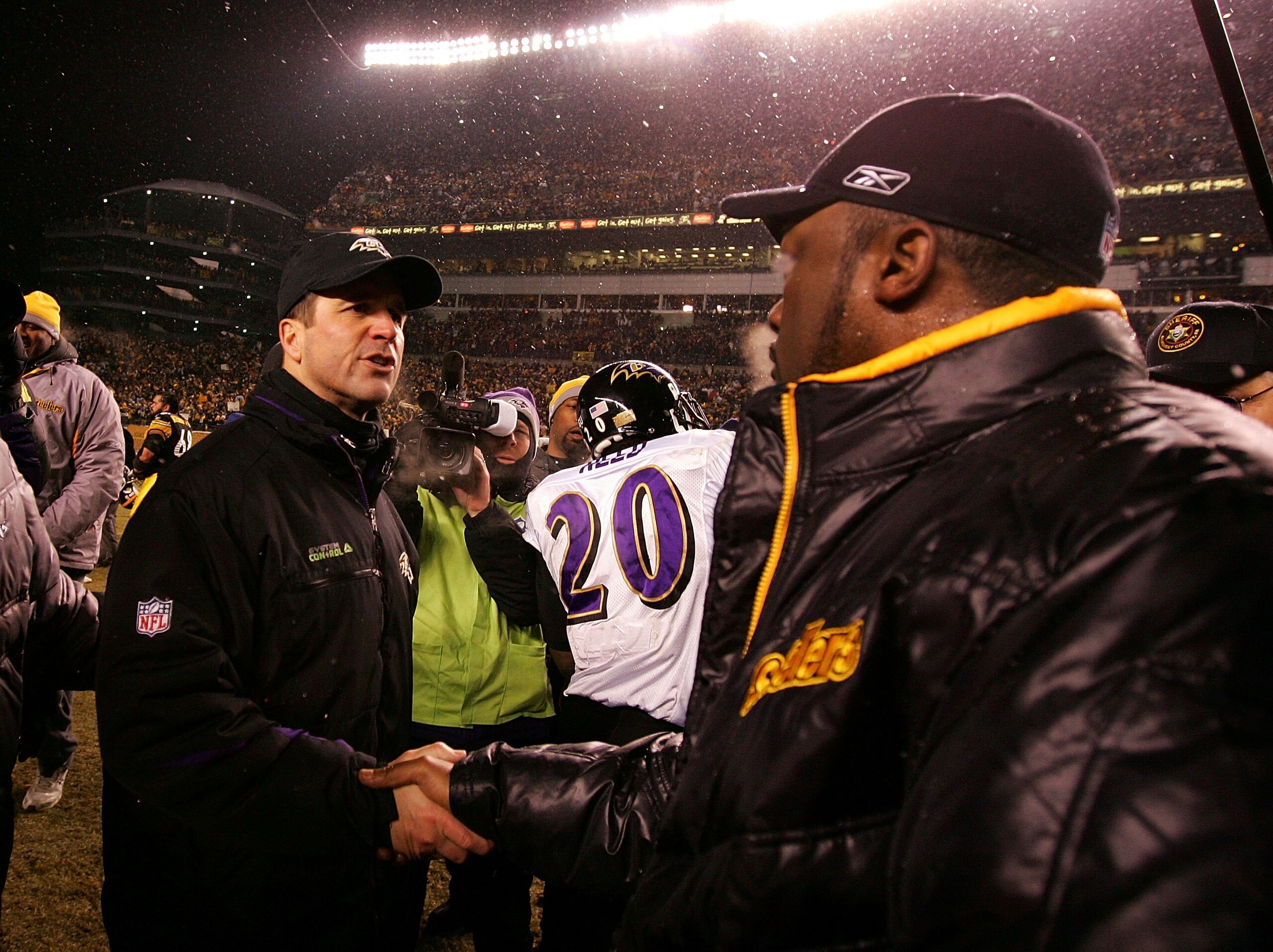 PITTSBURGH - JANUARY 18:  Head coach Mike Tomlin (R) of the Pittsburgh Steelers is congratulated by head coach John Harbaugh of the Baltimore Ravens after the Steelers won 23-14 during the AFC Championship game on January 18, 2009 at Heinz Field in Pittsb