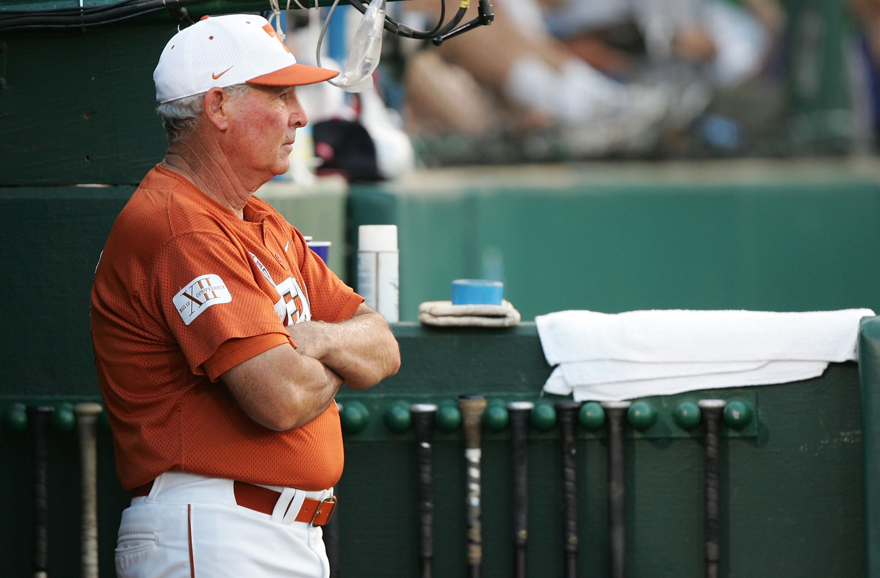 OMAHA, NE - JUNE 25:  Manager Augie Garrido #16 of the Texas Longhorns looks on from the dugout against the Florida Gators during Game 1 of the championship series of the 59th College World Series at Rosenblatt Stadium on June 25, 2005 in Omaha, Nebraska.