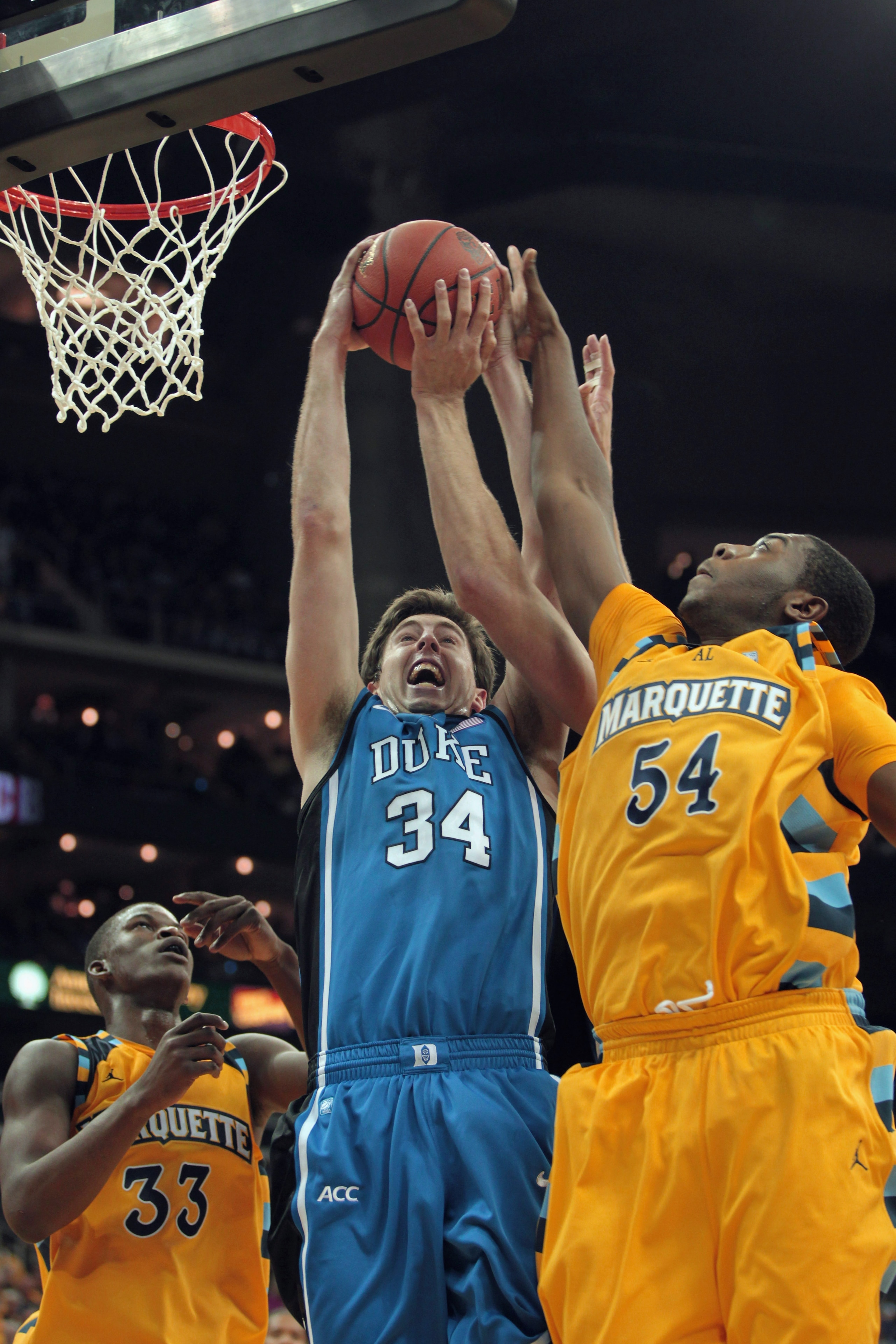 KANSAS CITY, MO - NOVEMBER 22:  Ryan Kelly #34 of the Duke Blue Devils battles Jimmy Butler #33 and Davante Gardner #54 of the Marquette Golden Eagles for a rebound during the CBE Classic game on November 22, 2010 at the Sprint Center in Kansas City, Miss