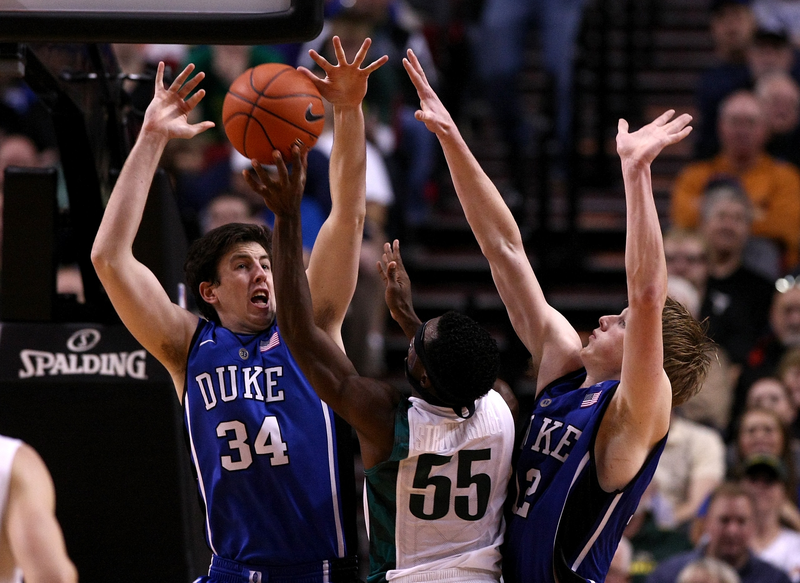 PORTLAND, OR - NOVEMBER 27:  Jay-R Strowbridge #55 of the Oregon Ducks is has his shot blocked by Ryan Kelly #34 and Kyle Singler #12 of the Duke Blue Devils on November 27, 2010 at the Rose Garden in Portland, Oregon.  (Photo by Jonathan Ferrey/Getty Ima