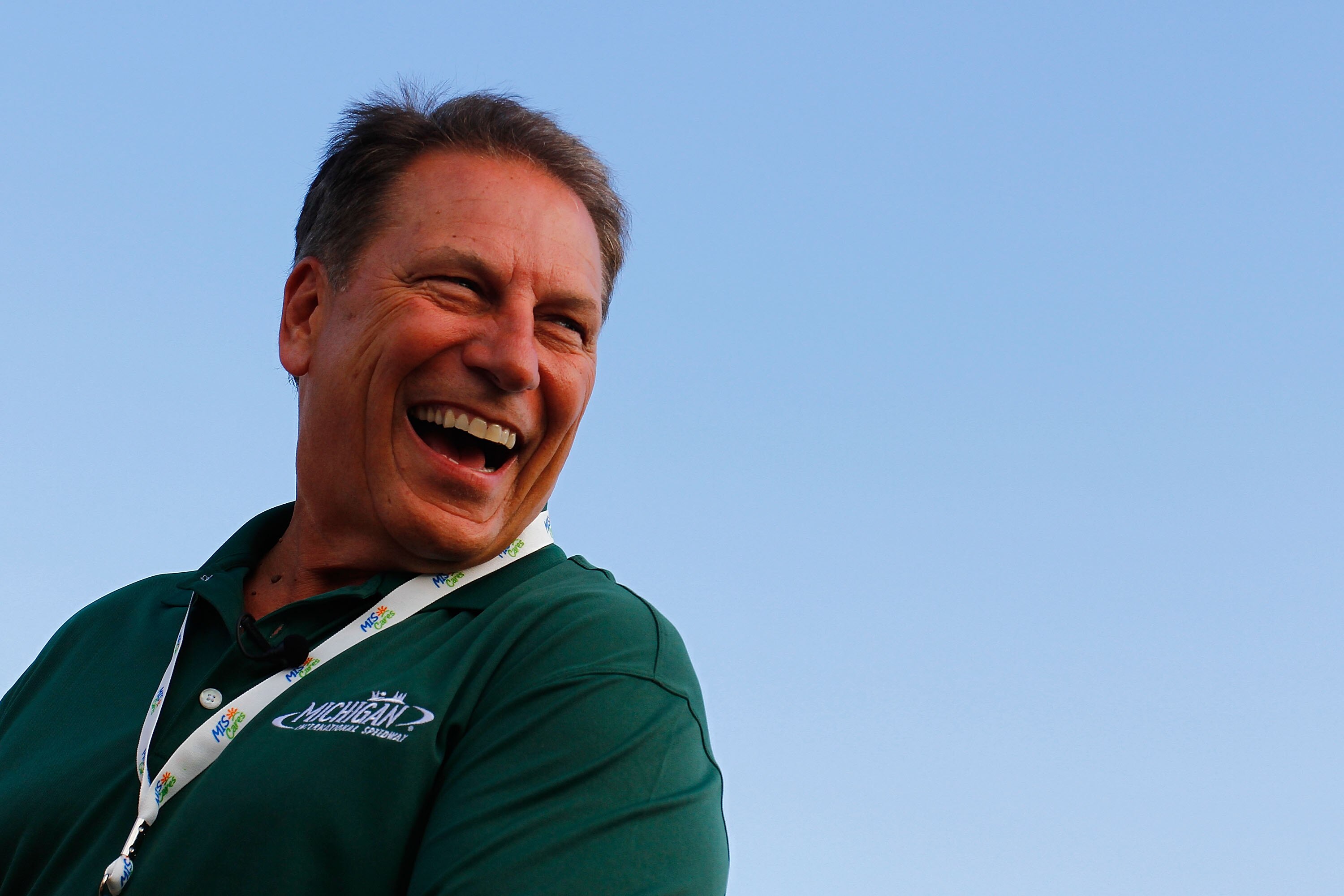 BROOKLYN, MI - AUGUST 15:  Tom Izzo, head coach of the Michigan State Spartans men's basketball team smiles as he gets ready to take a ride on the track in a pace car prior to the running of the NASCAR Sprint Cup Series CARFAX 400 at Michigan Internationa