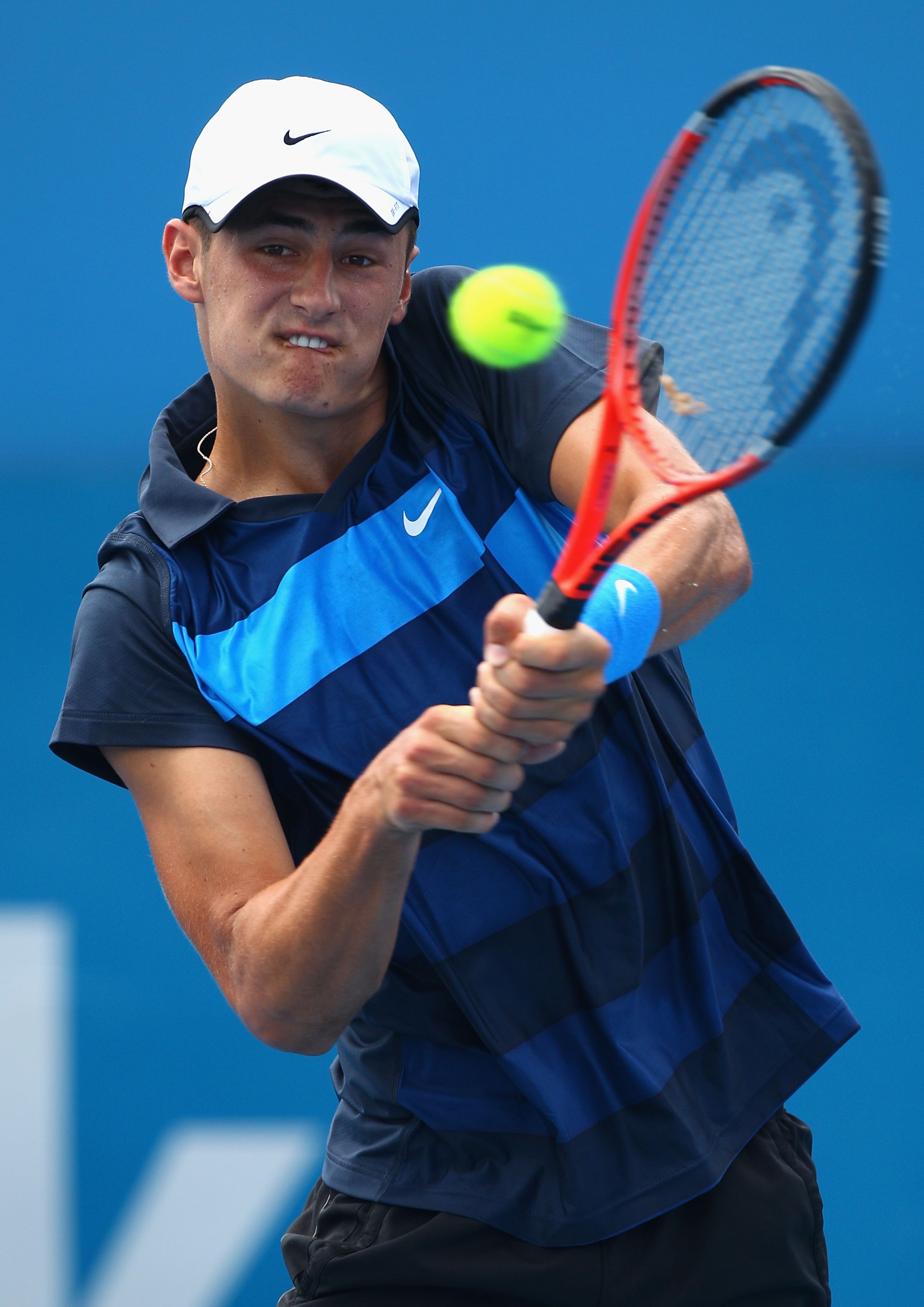 SYDNEY, AUSTRALIA - JANUARY 09: Bernard Tomic of Australia hits a backhand during his qualifying match Lukasz Kubot of Poland during day one of the 2011 Medibank International at Sydney Olympic Park Tennis Centre on January 9, 2011 in Sydney, Australia.
