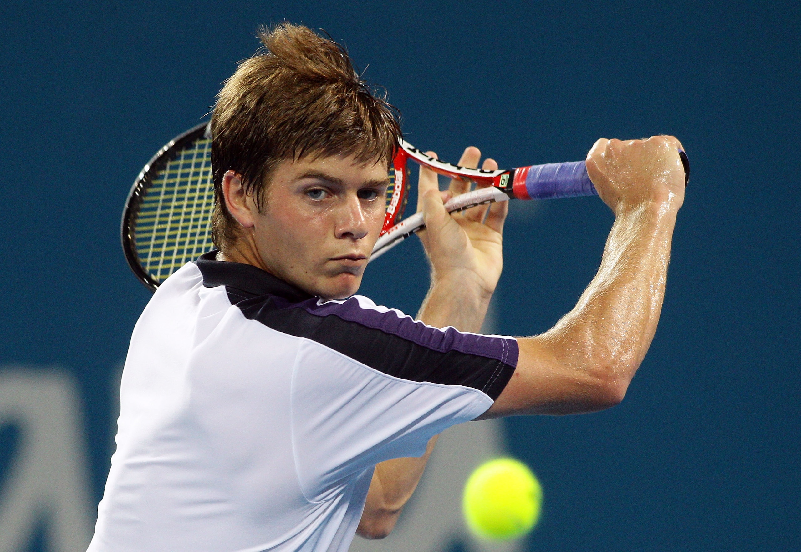 BRISBANE, AUSTRALIA - JANUARY 04: Ryan Harrison of the USA plays a backhand during his first round match against Robin Soderling of Sweden during day three of the Brisbane International at Queensland Tennis Centre on January 4, 2011 in Brisbane, Australia