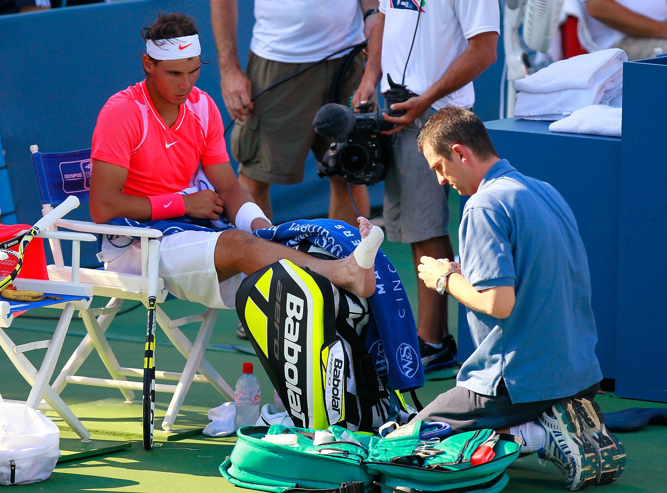CINCINNATI - AUGUST 19:  Rafael Nadal of Spain has his right foot attended to by a trainer after winning the second set against Julien Benneteau of France during Day 4 of the Western & Southern Financial Group Masters at the Lindner Family Tennis Center o