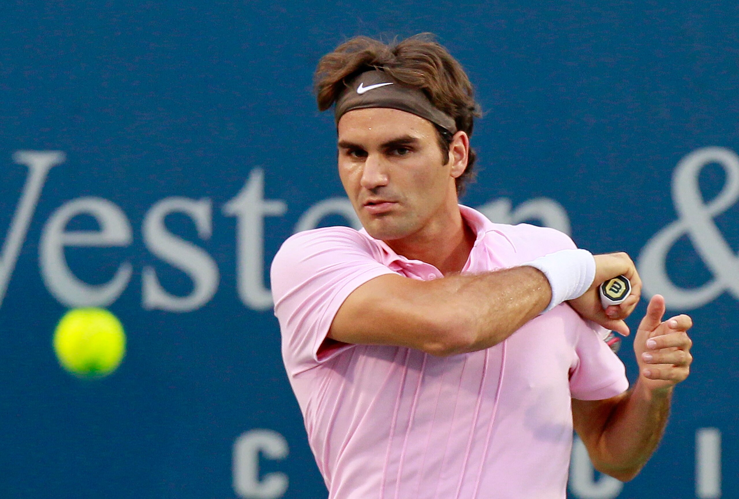 CINCINNATI - AUGUST 21:  Roger Federer of Switzerland returns a forehand to Marcos Baghdatis of Cyprus during the semifinals on Day 6 of the Western & Southern Financial Group Masters at the Lindner Family Tennis Center on August 21, 2010 in Cincinnati, O