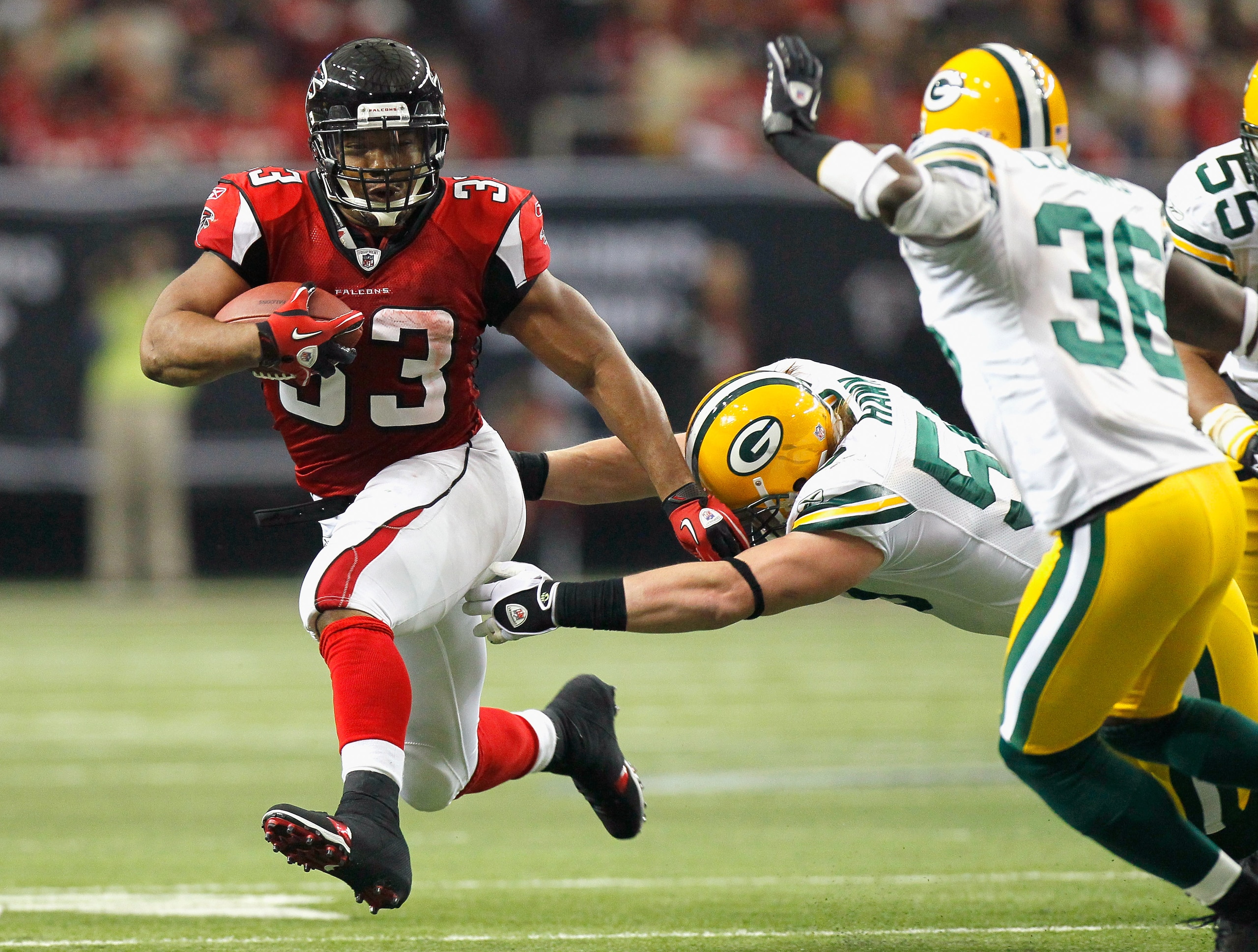 ATLANTA - NOVEMBER 28: Michael Turner #33 of the Atlanta Falcons rushes rushes upfield away from A.J. Hawk #50 and Nick Collins #36 of the Green Bay Packers at Georgia Dome on November 28, 2010 in Atlanta, Georgia. (Photo by Kevin C. Cox/Getty Images) ATLANTA - NOVEMBER 28: Michael Turner #33 of the Atlanta Falcons rushes rushes upfield away from A.J. Hawk #50 and Nick Collins #36 of the Green Bay Packers at Georgia Dome on November 28, 2010 in Atlanta, Georgia. (Photo by Kevin C. Cox/Getty Images)