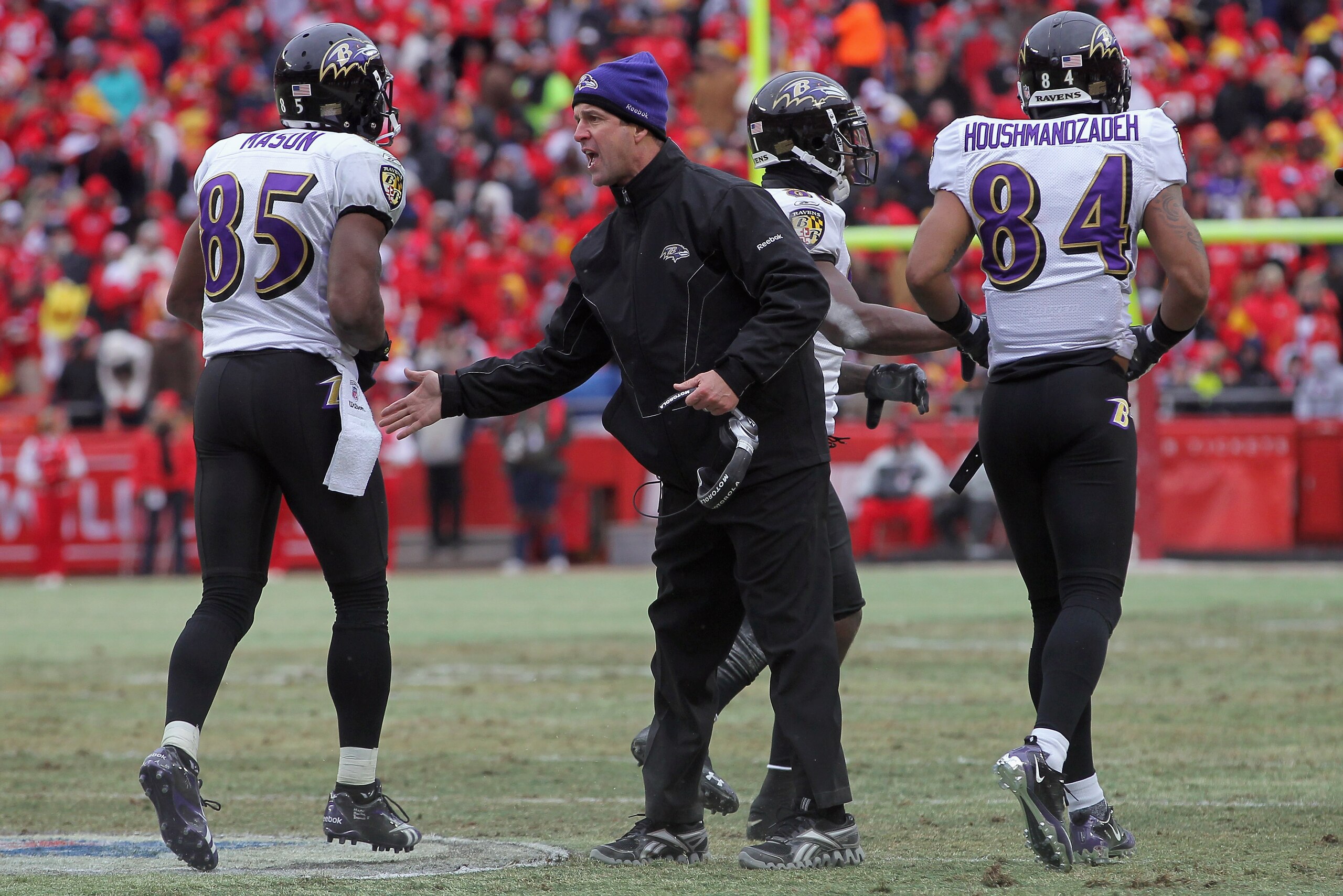 KANSAS CITY, MO - JANUARY 09: Head coach John Harbaugh of the Baltimore Ravens welcomes wide receivers Derrick Mason #85 and T.J. Houshmandzadeh back to the bench during their 2011 AFC wild card playoff game against the Kansas City Chiefs at Arrowhead Sta KANSAS CITY, MO - JANUARY 09: Head coach John Harbaugh of the Baltimore Ravens welcomes wide receivers Derrick Mason #85 and T.J. Houshmandzadeh back to the bench during their 2011 AFC wild card playoff game against the Kansas City Chiefs at Arrowhead Sta