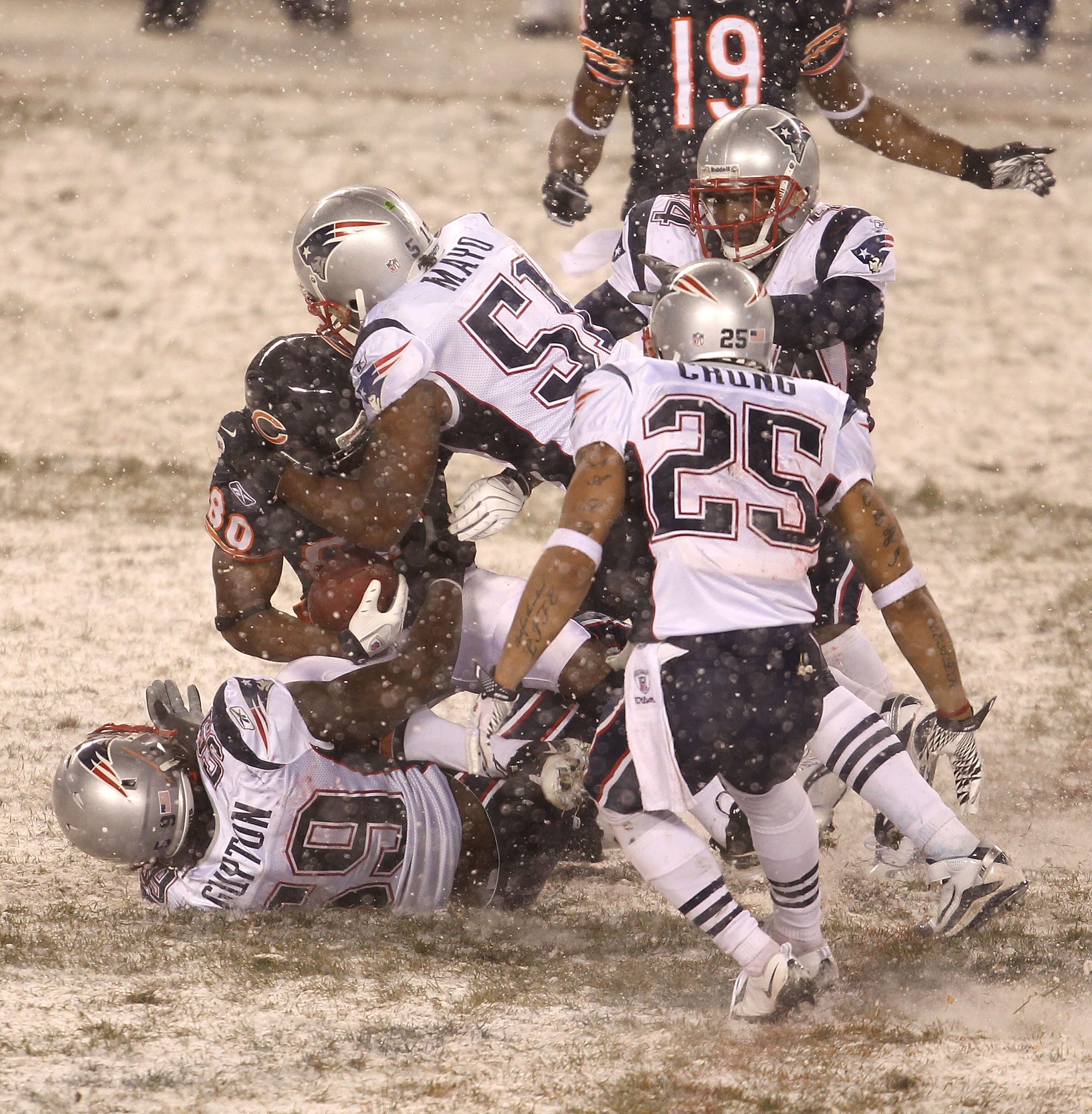 CHICAGO, IL - DECEMBER 12: Earl Bennett #80 of the Chicago Bears is gang-tackled by Gary Guyton #59, Jerod Mayo #51, Patrick Chung #25 and Jarred Page #44 of the New England Patriots at Soldier Field on December 12, 2010 in Chicago, Illinois. The Patriots