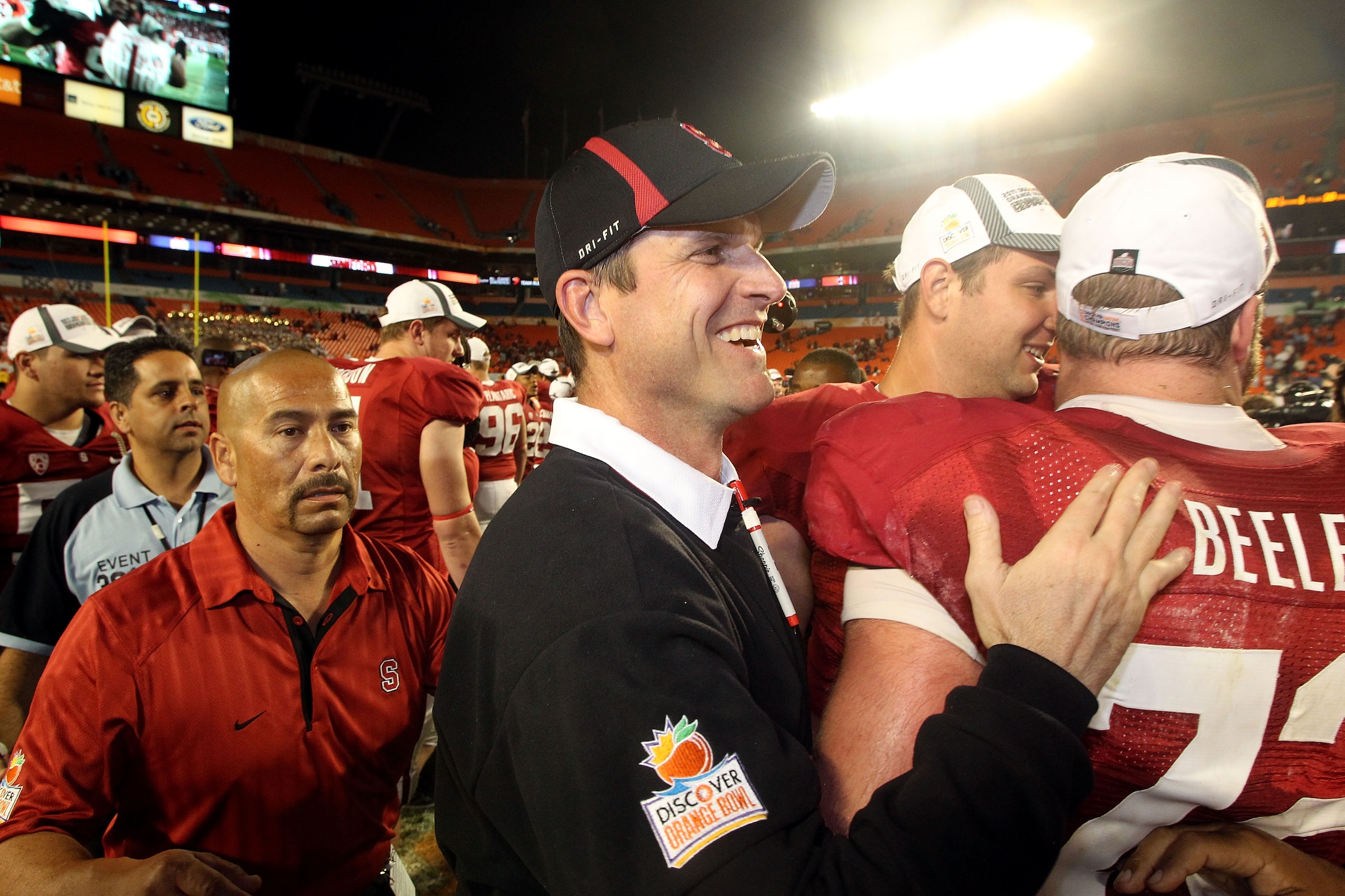 MIAMI, FL - JANUARY 03:  Head coach Jim Harbaugh of the Stanford Cardinal celebrates with his players after Stanford won 40-12 against the Virginia Tech Hokies during the 2011 Discover Orange Bowl at Sun Life Stadium on January 3, 2011 in Miami, Florida.
