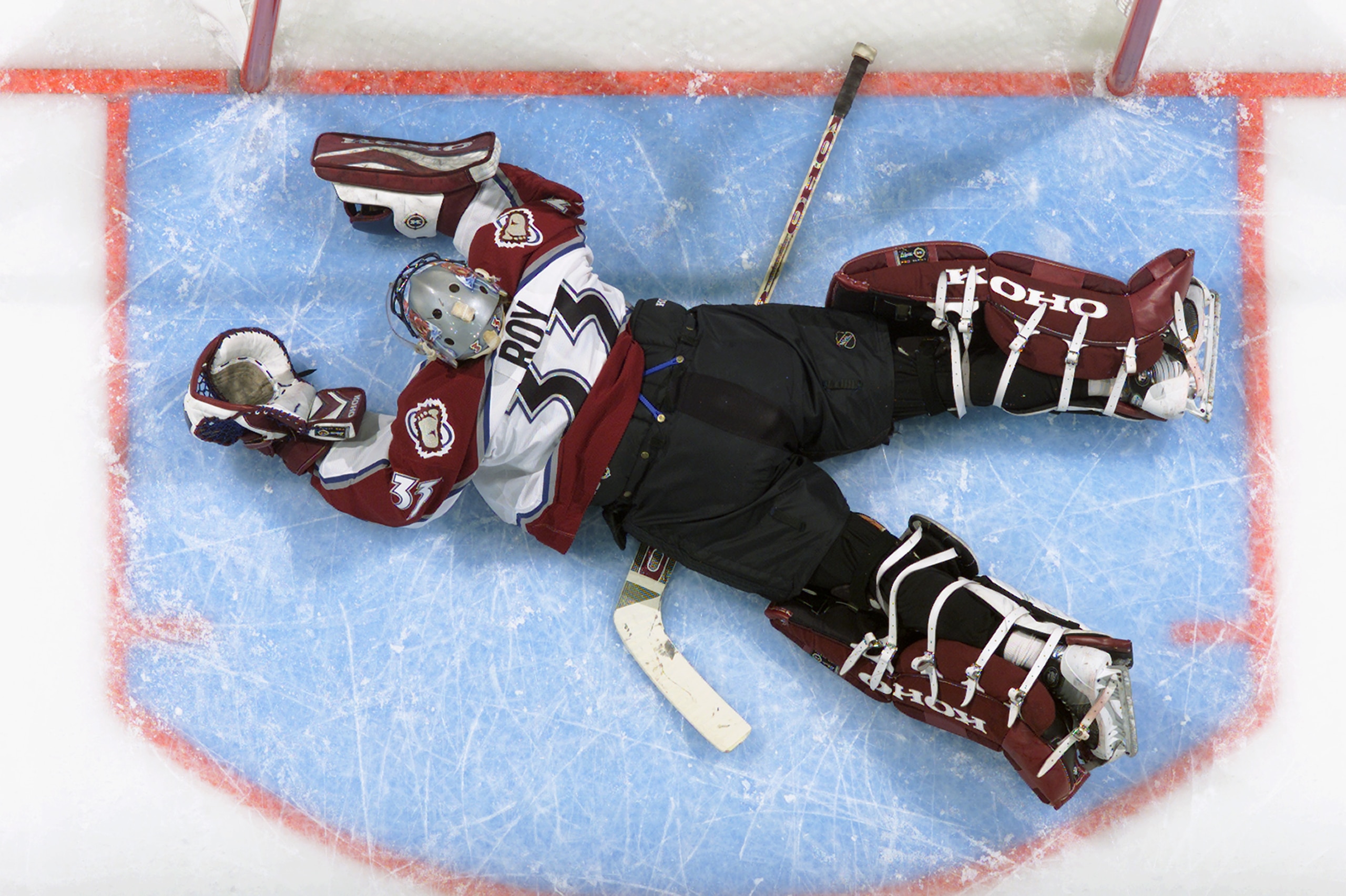 DENVER - APRIL 19:  Goalie Patrick Roy #33 of the Colorado Avalanche dives but can't stop Patrick Kuba of the Minnesota Wild from scoring during game five of the first round of the 2003 Western Conference Stanley Cup playoffs on April 19, 2003 at the Peps